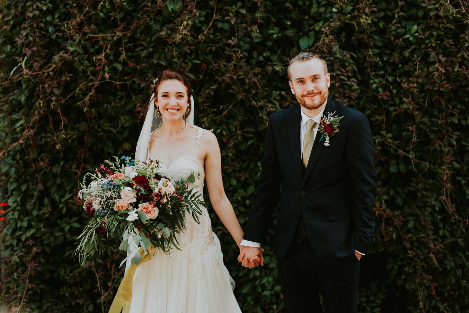 Woodland wedding couple with large rustic bouquet