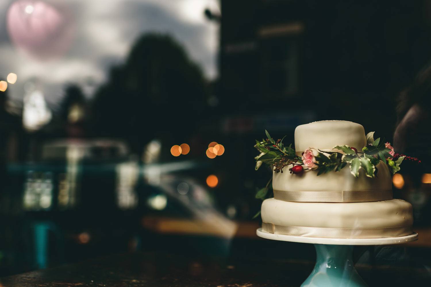 Wedding cake with flowers in window