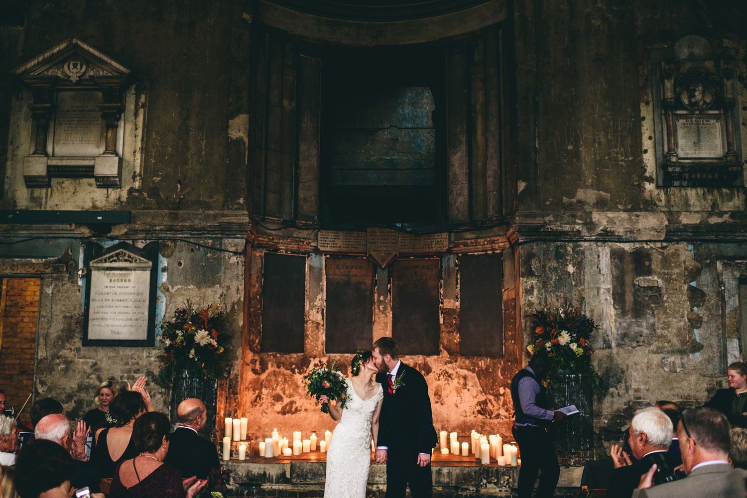 Candlelit wedding with couple kissing at Asylum chapel