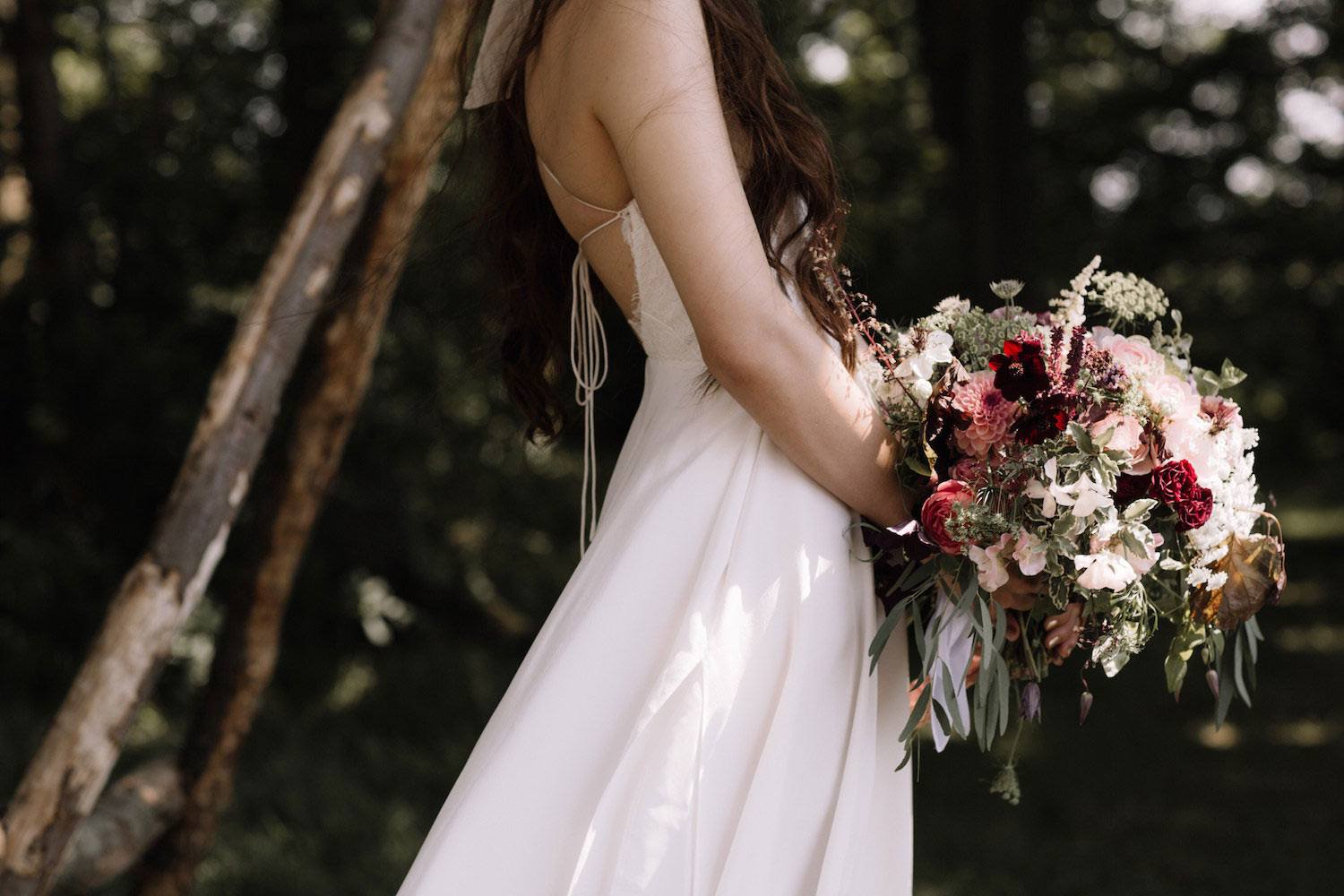 Bride holding dark velvety bridal bouquet