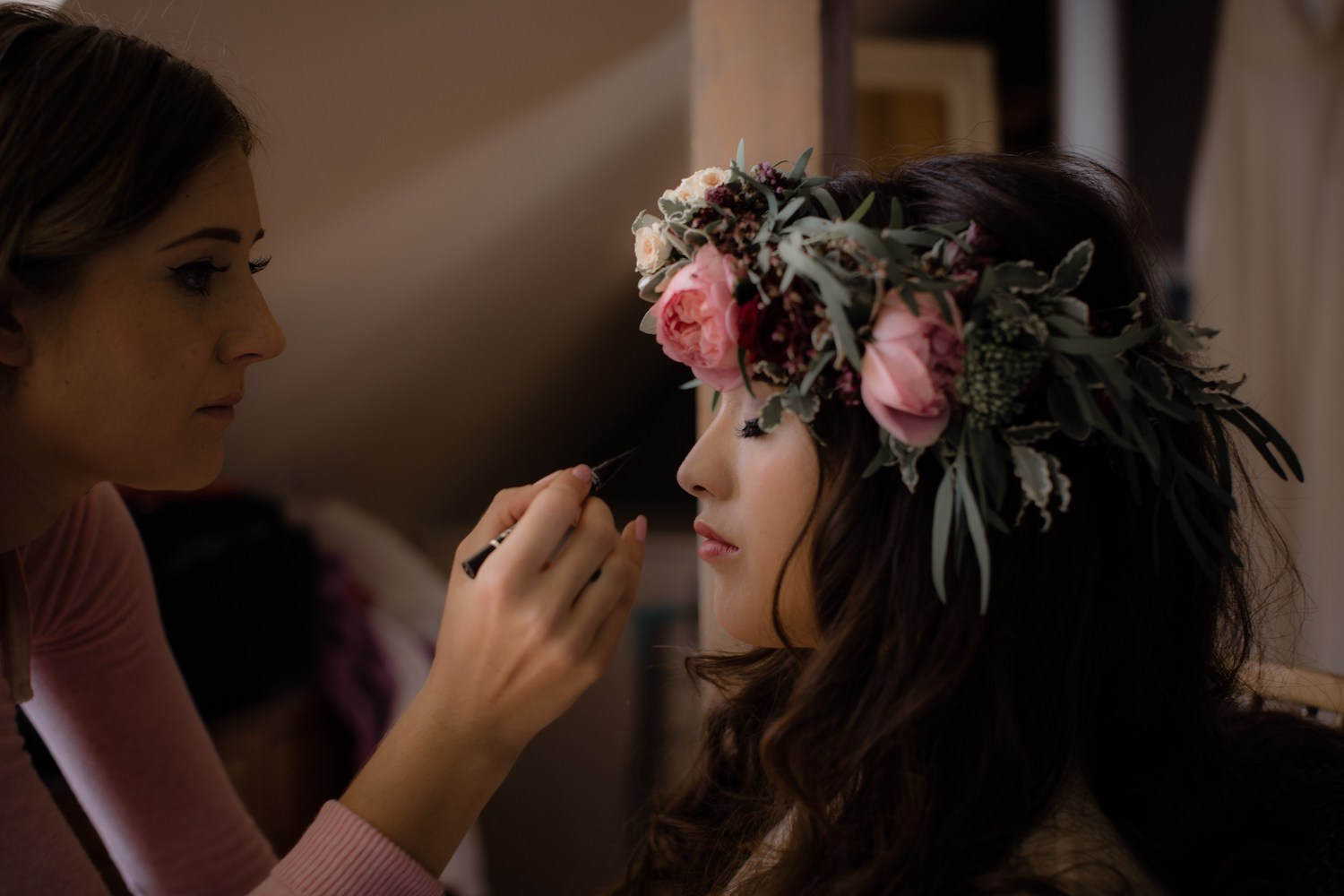 Bride with large rose flower crown having make up 