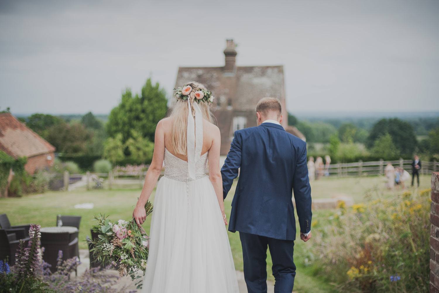 Bride and groom arriving at garden party