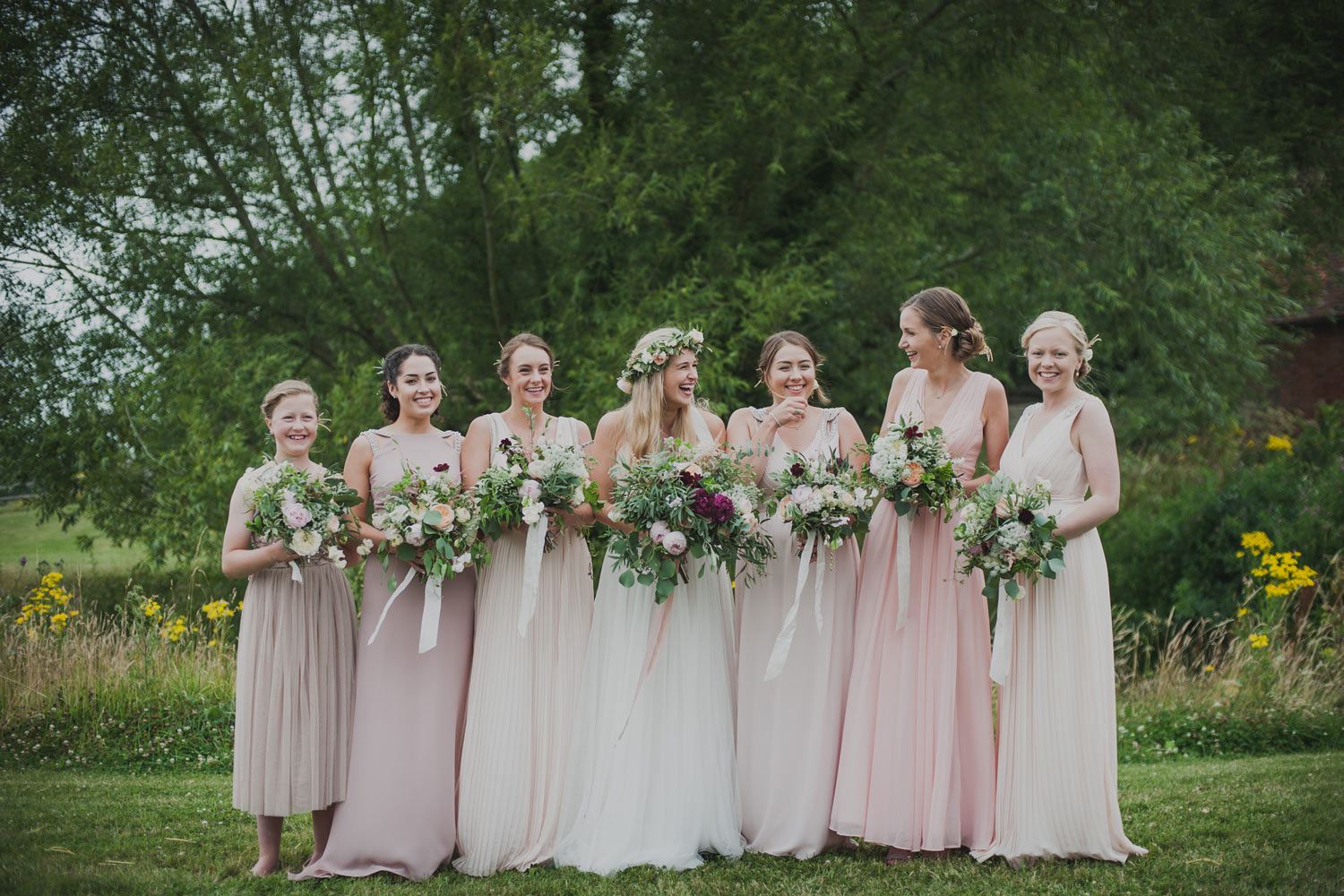 Pale pink bridesmaids and bride with their garden bouquets