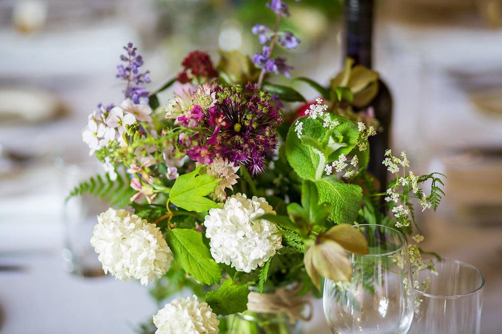 spring wild flowers in jar on wedding table