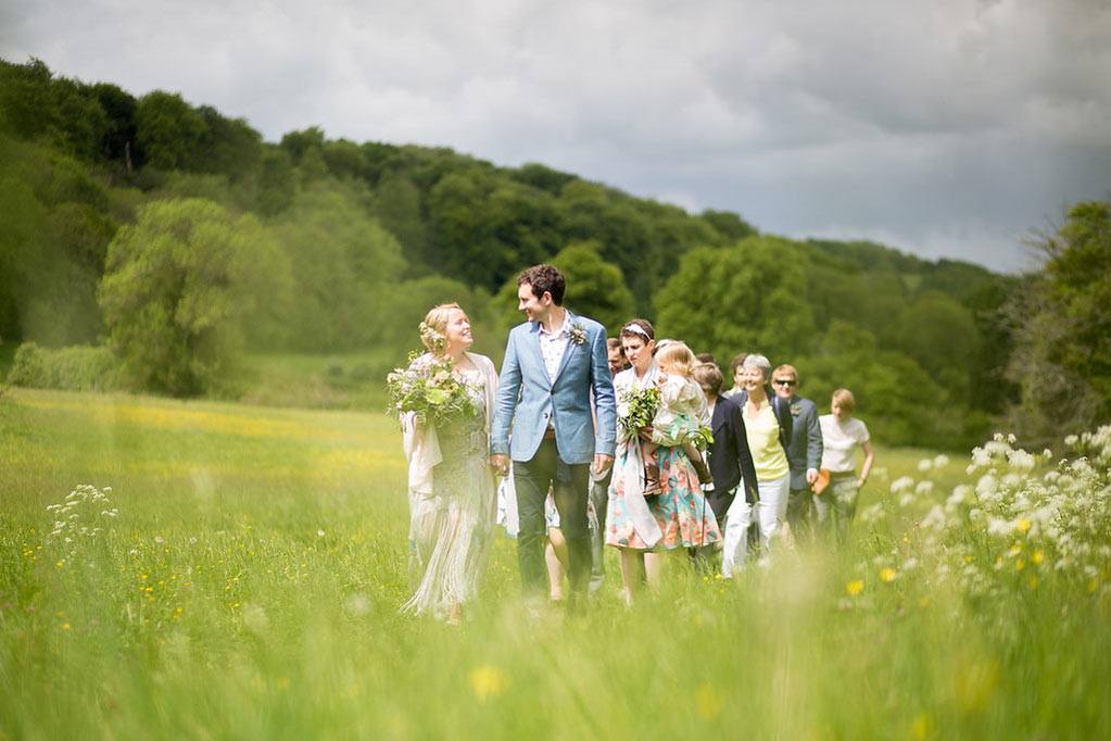 Wedding procession in spring meadow