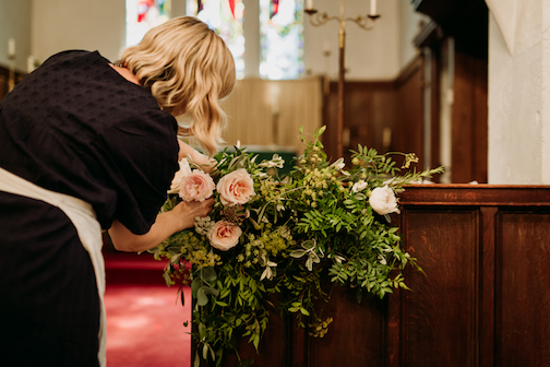 Bea arranging roses on church altar
