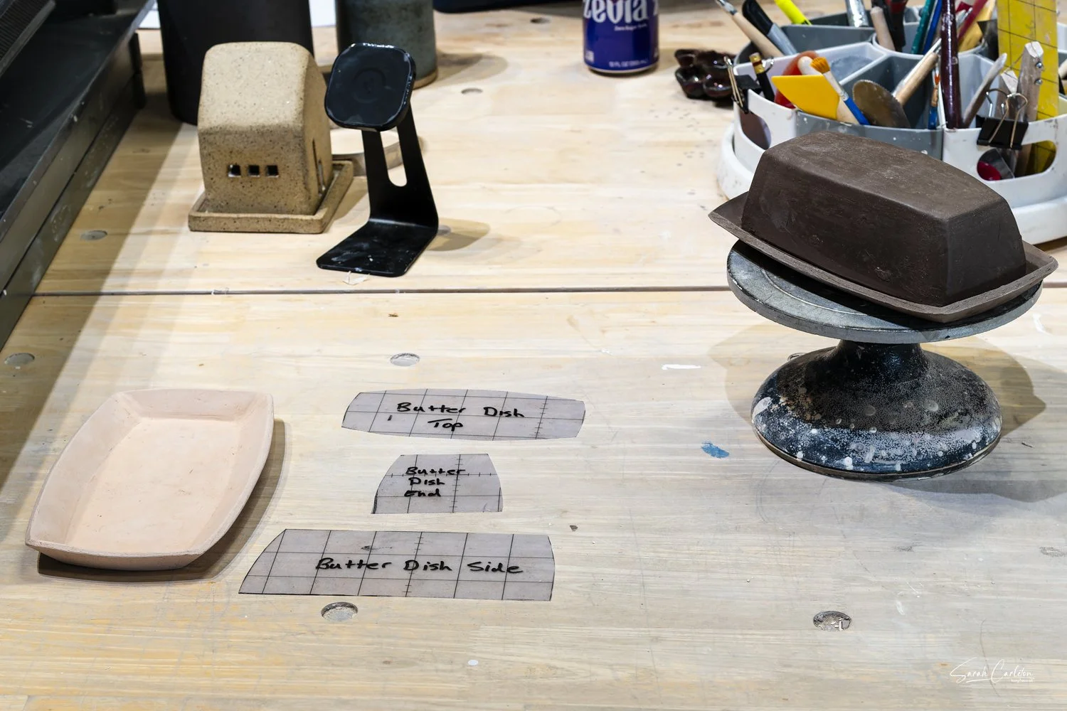 Clay and patterns on a workbench.