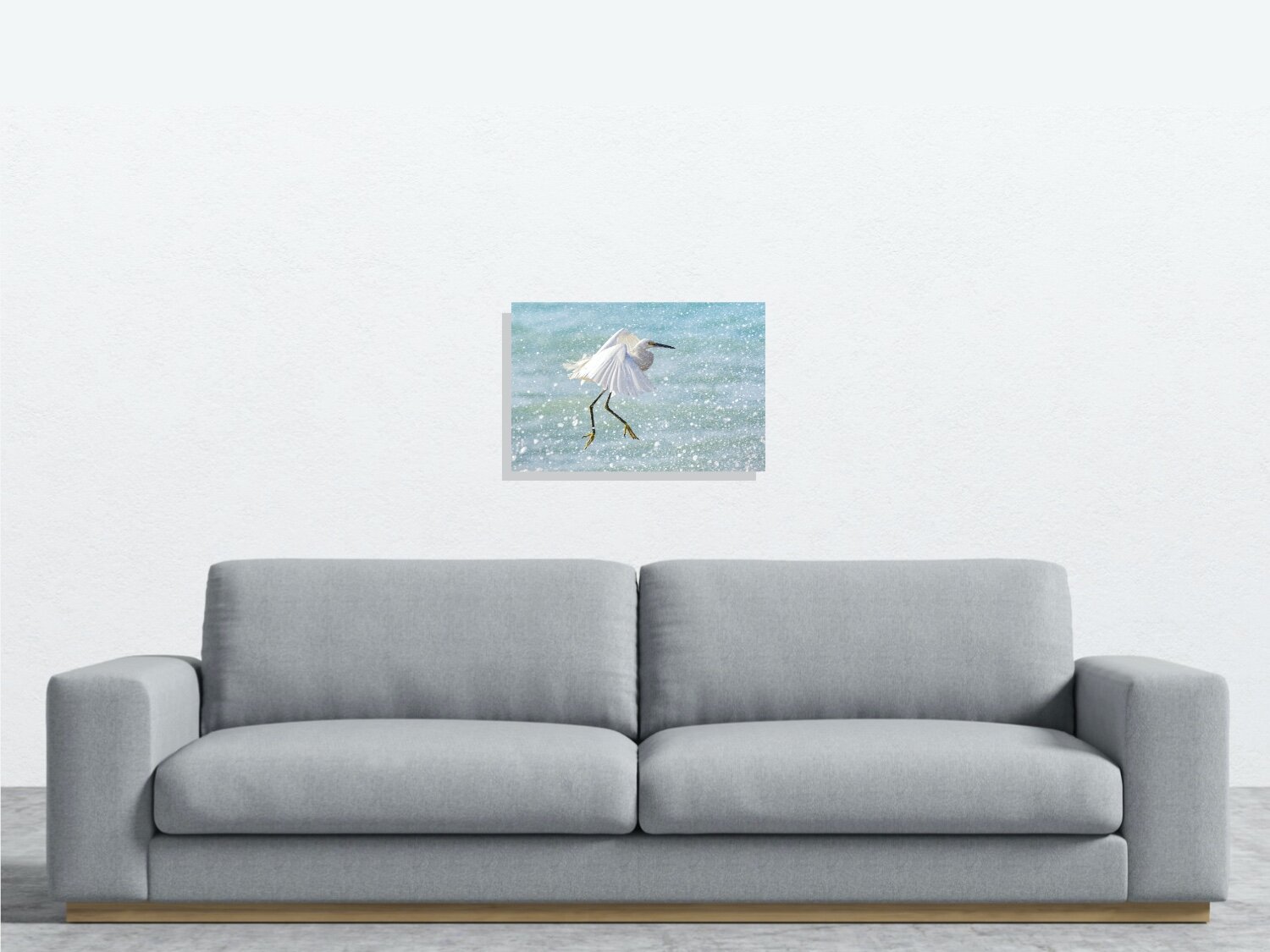 24" print on wall behind sofa.