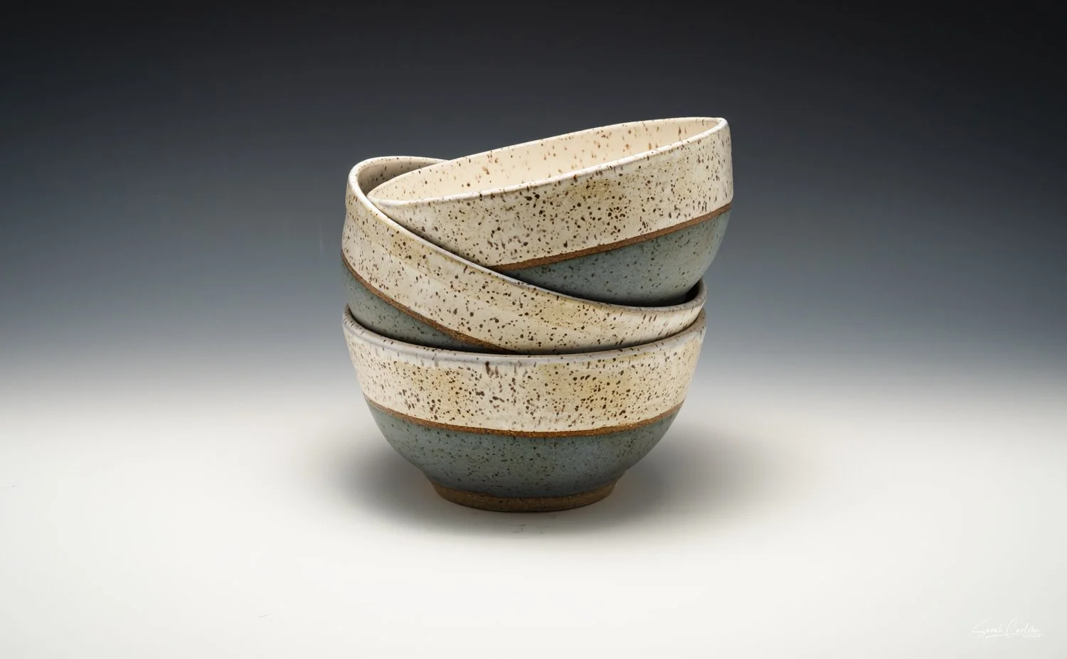 Three stacked ceramic ice cream bowls.