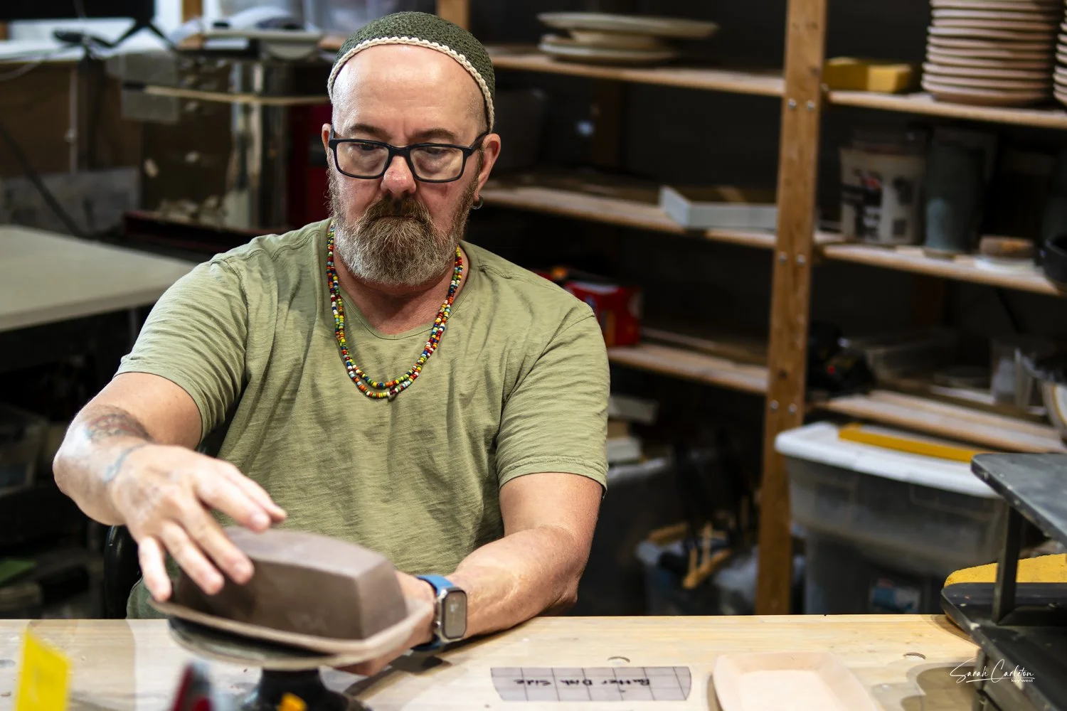 Mark considering the shape of a butter dish.