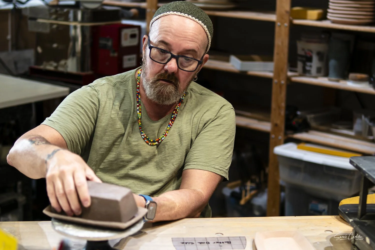 Mark handling clay forms.