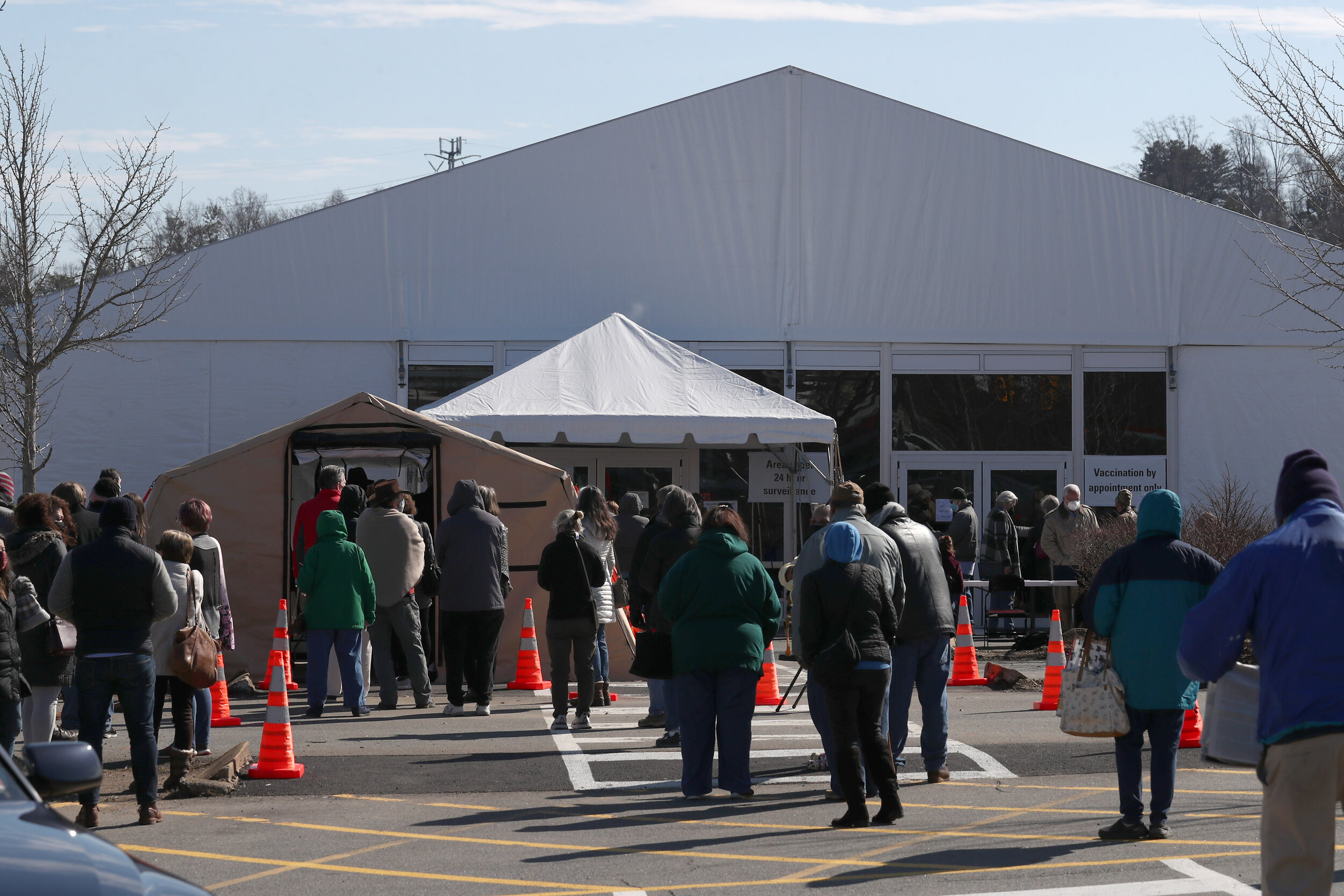  A long line of people waiting to their COVID-19 vaccine at the Blue Ridge Heath District vaccine clinic extends the length of the former Kmart parking on Wednesday, Feb. 17 in Charlottesville, Virginia. 