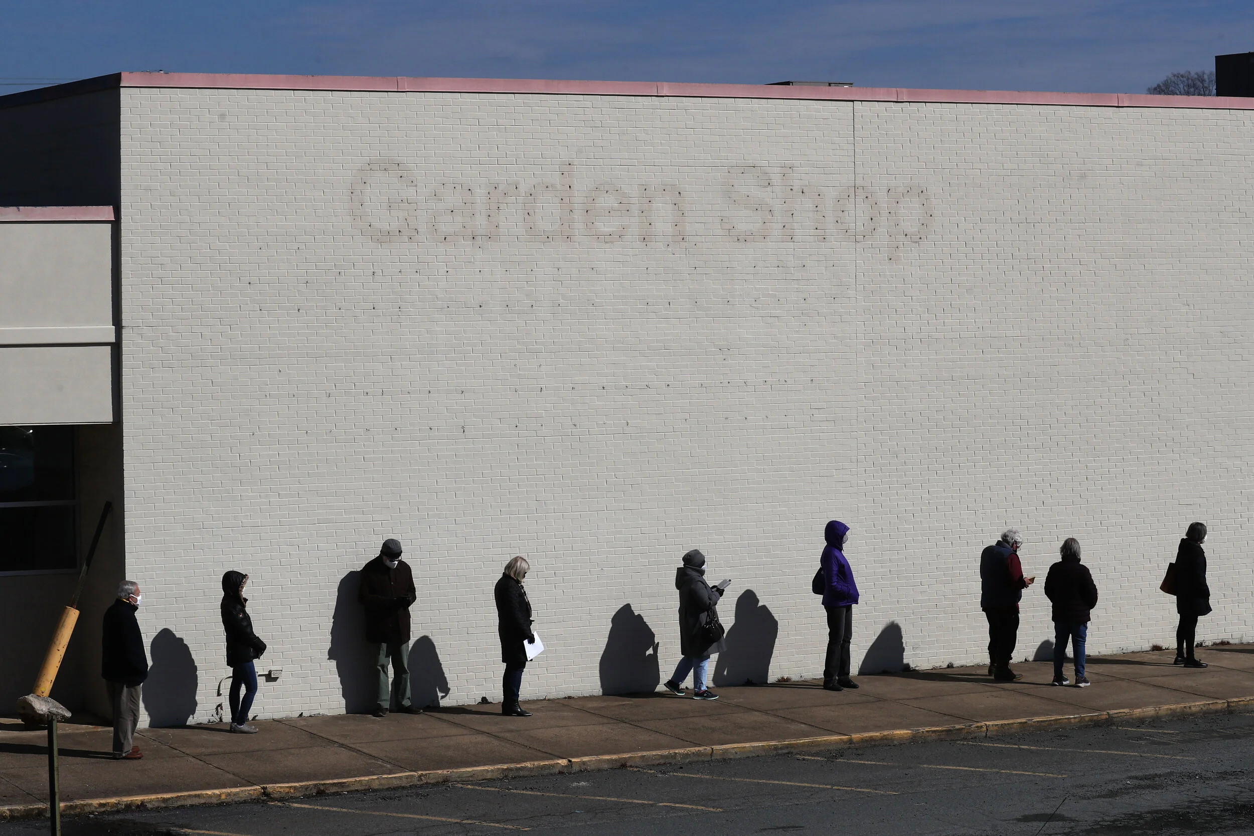 A long line of people waiting to their COVID-19 vaccine at the Blue Ridge Heath District vaccine clinic extends the length of the former Kmart parking on Wednesday, Feb. 17 in Charlottesville, Virginia. 