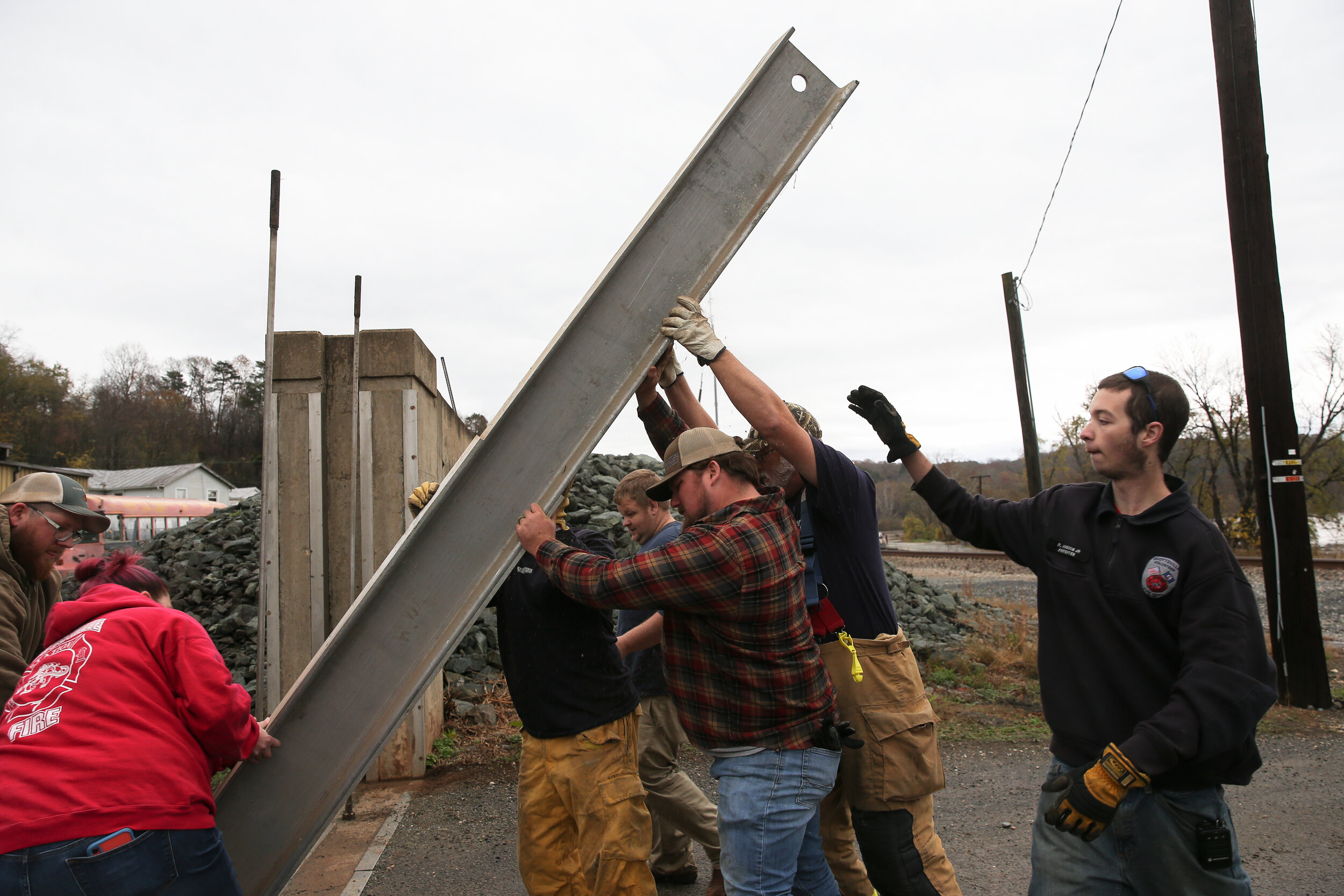 Scottsville Volunteer Fire Department and other community members install the flood wall on Thursday, Nov. 12, 2020 at Ferry Street. The crew of 20 people install the wall swiftly as the river is forecasted to crest at 21.5 feet.