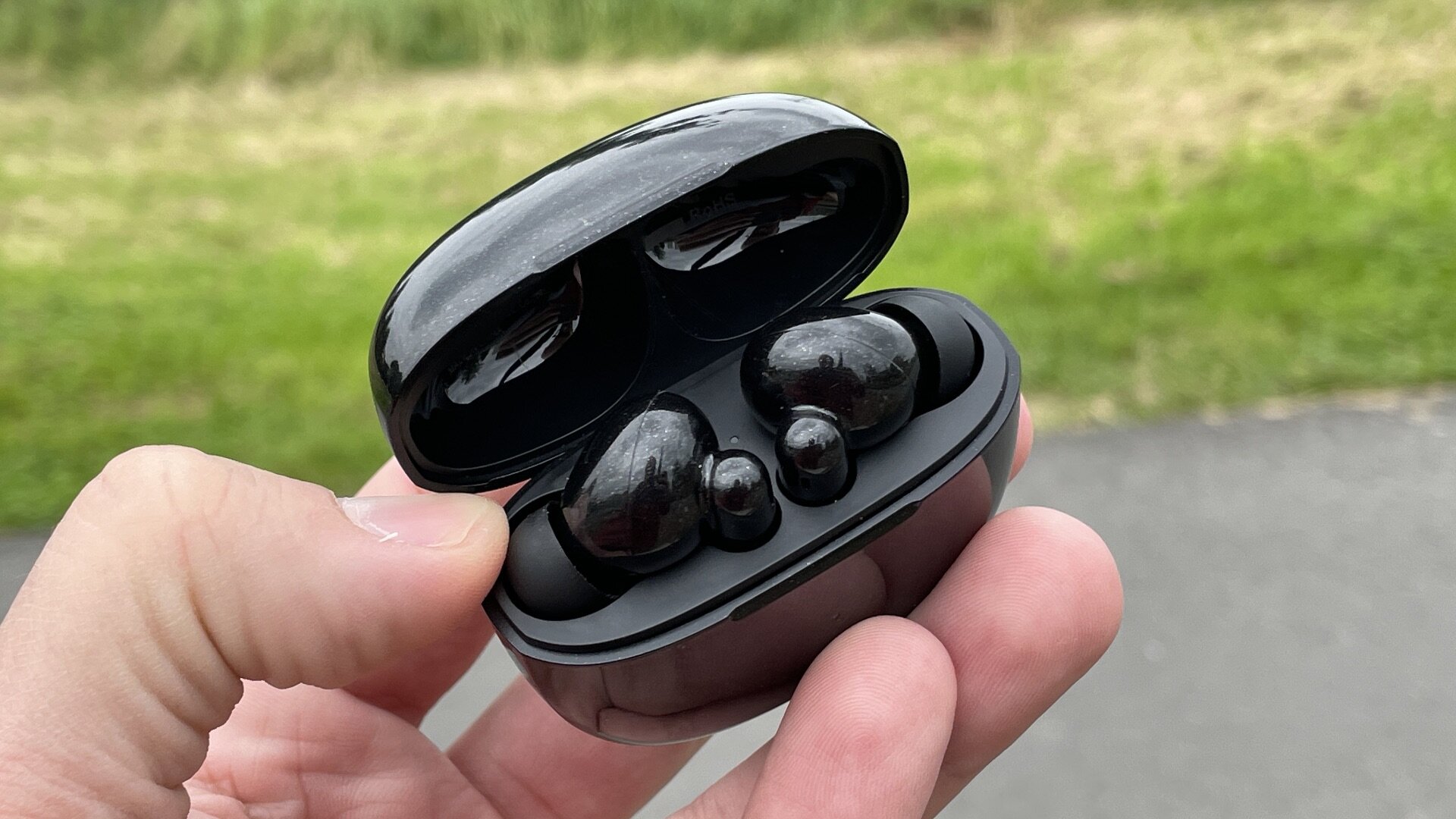 Grab the earbuds by the ear tips to get them out of the case the easiest way