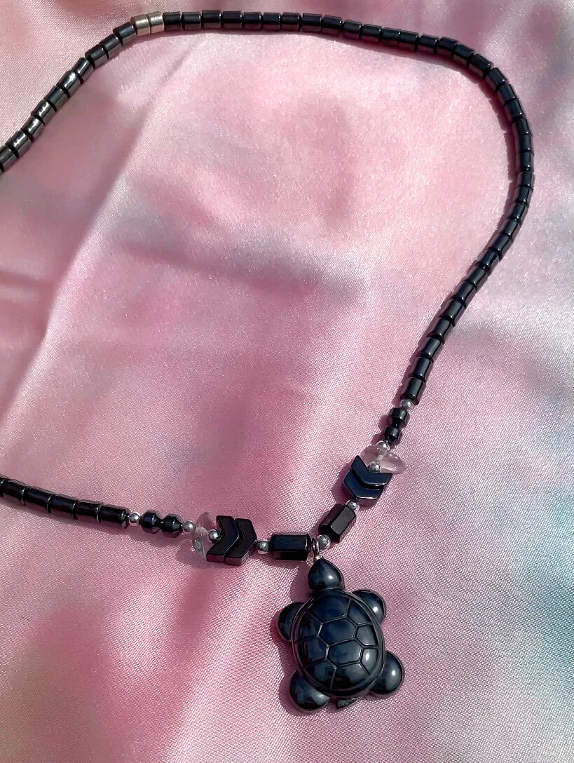 one of a kind hematite necklace shaped like a turtle close up