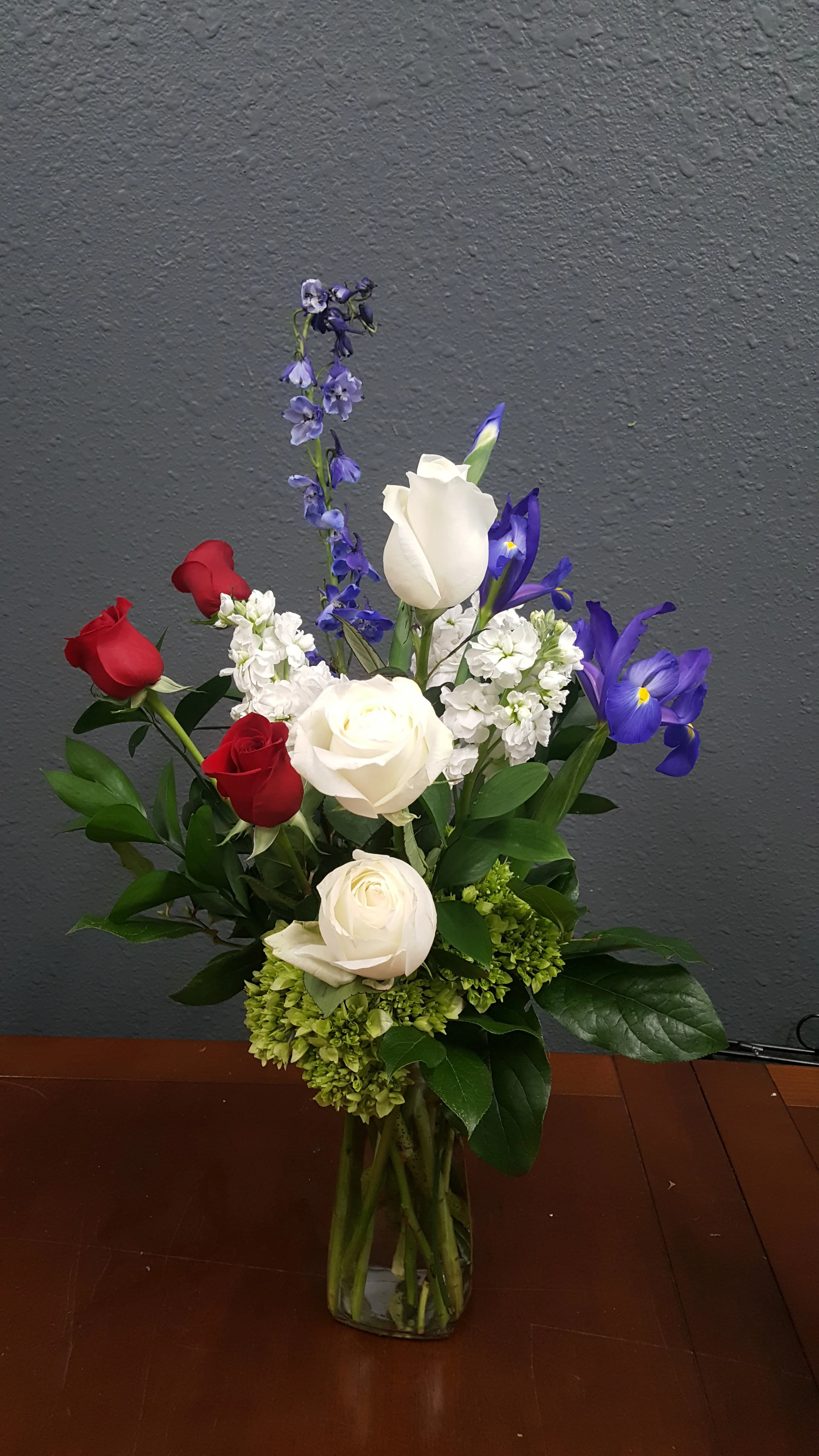 A patriotic vase arrangement in red, white and blue.