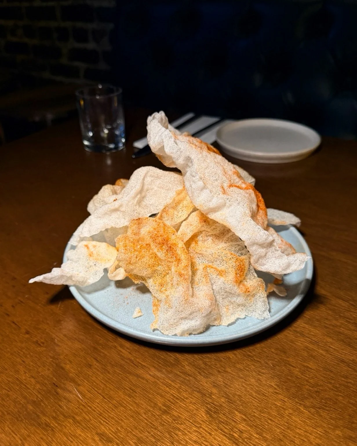 We highly recommend ordering these just for the sound effects. Meet our Vegan Chicharr&oacute;n. Ridiculously crispy, rice-based bites tossed in paprika and cumin. They pair perfectly with whatever the bartender just poured you&mdash;and they disappe