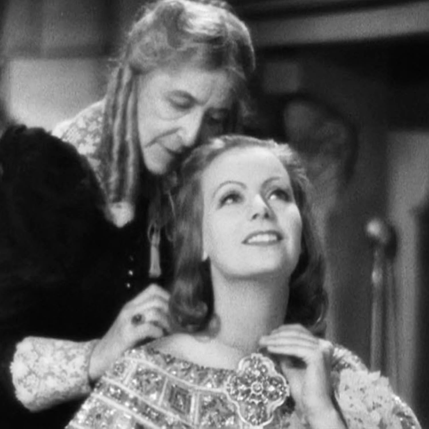 Greta Garbo getting dress and chatting with her handmaiden. This was the best image we had of the pendant.