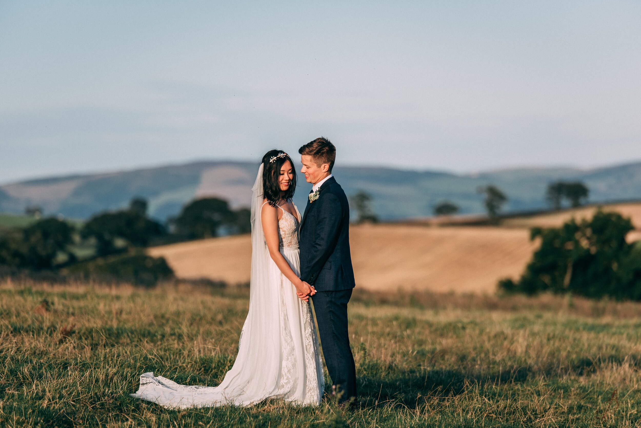 A stunning lace wedding dress and Tilly Thomas Lux Calypso headpiece for a relaxed wedding