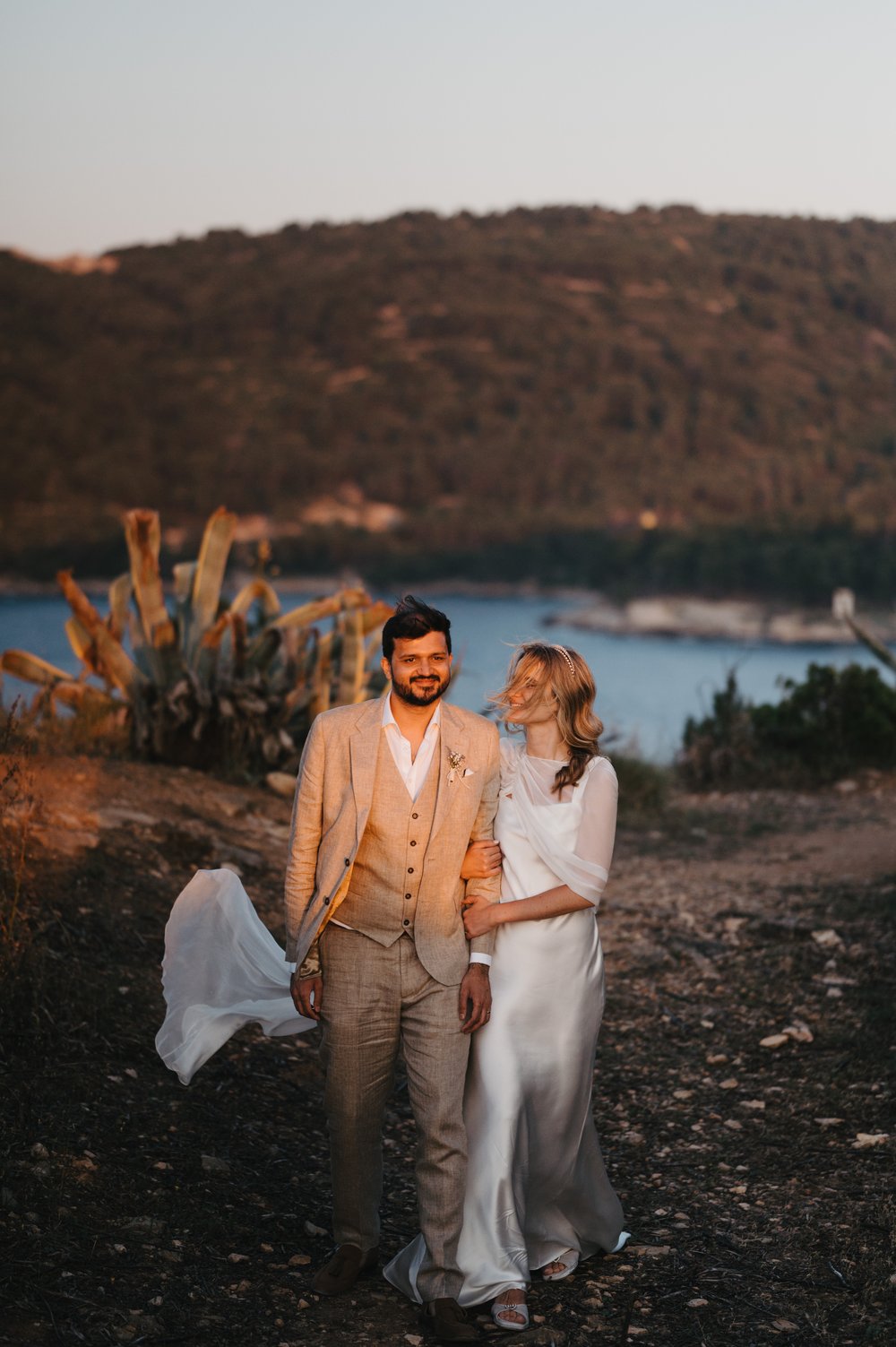 Stacked Tilly Thomas Lux crowns and a sheer cape for a stunning wedding in Croatia