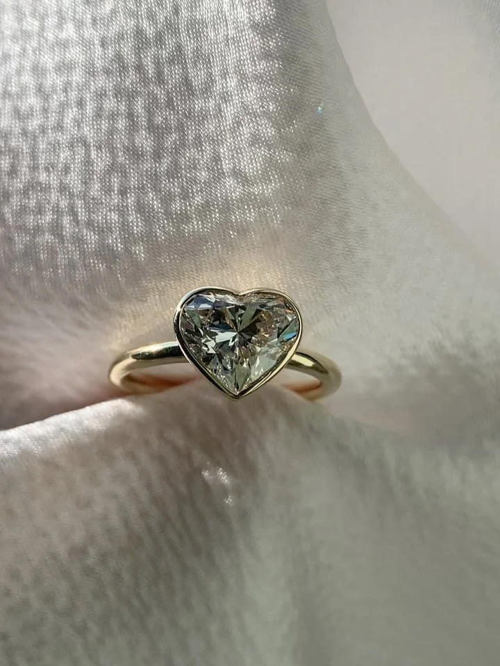 Bespoke 2ct Heart-Cut Diamond 9ct Gold Ring 🤍

Designed for our client, this beautiful heart-cut diamond sits in a minimal setting that lets the stone shine.
We sourced this colourless D-grade 2ct diamond &mdash; an incredible stone with the most st