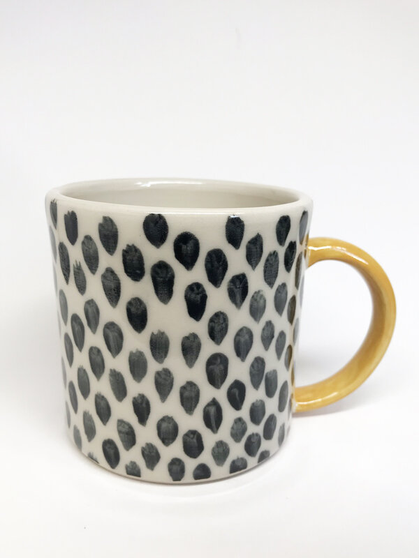 Black spotty mug, yellow handle