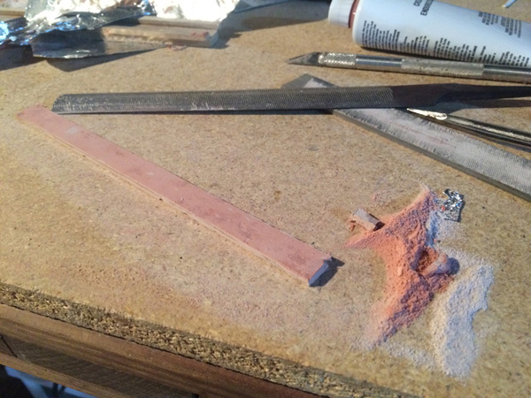 The rough half round file in the cheap assorted pack will make quick work of cured Bondo.