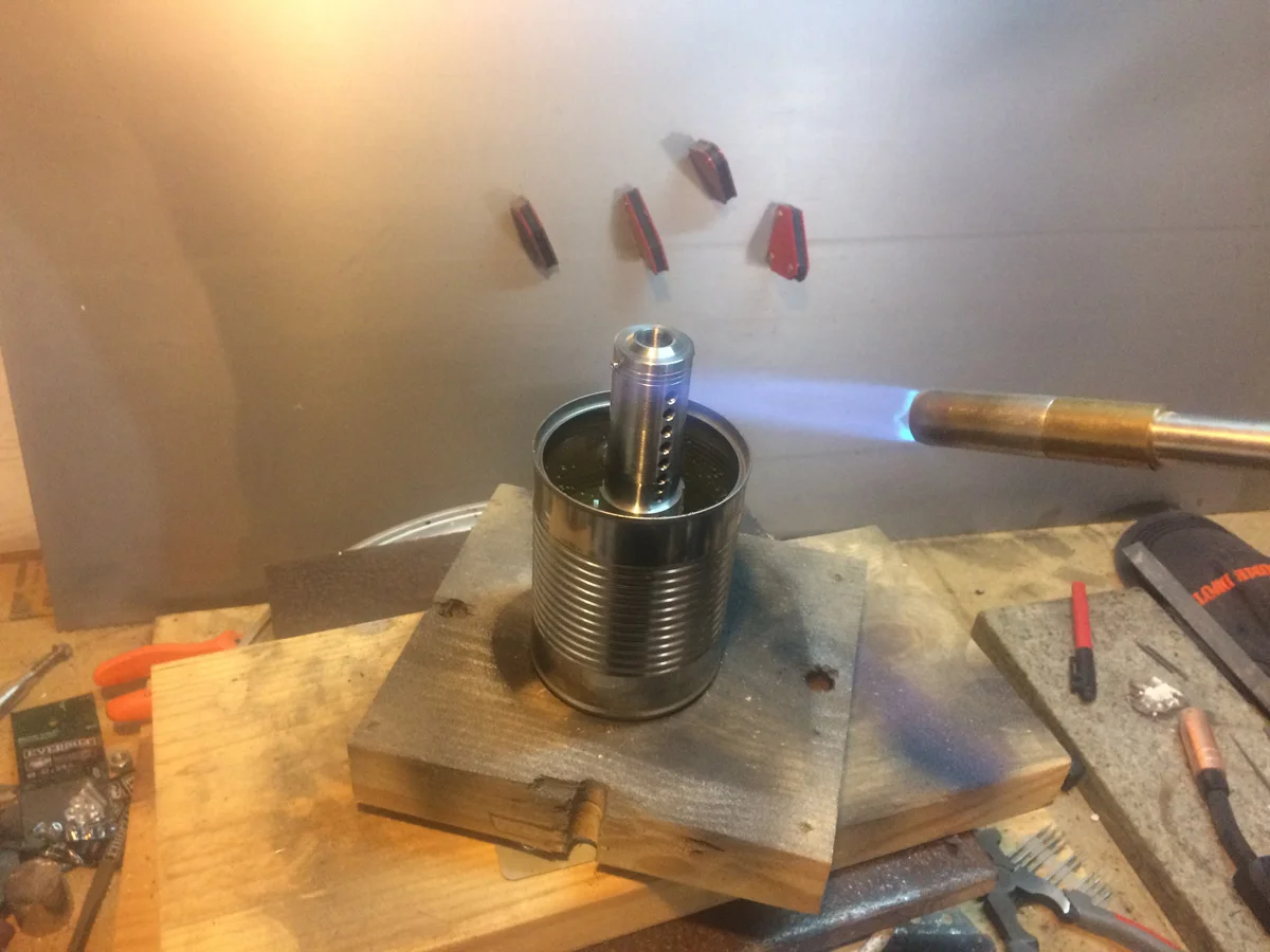 Stainless for true heat-discoloration rather than painted aluminum.
