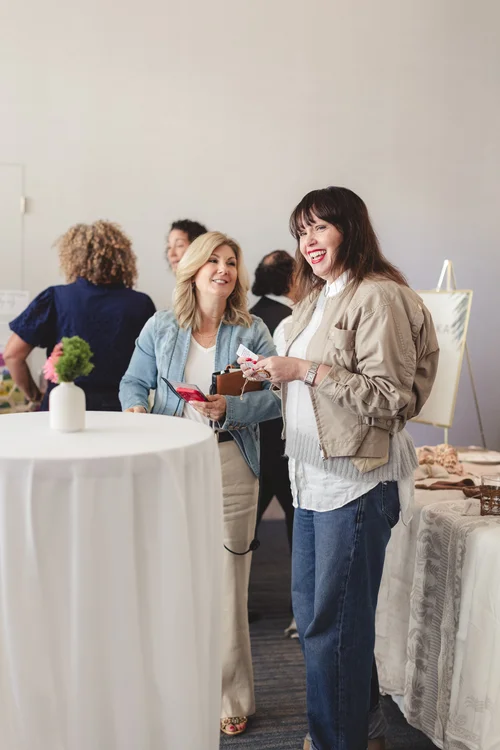 Women laughing at a FemCity networking event