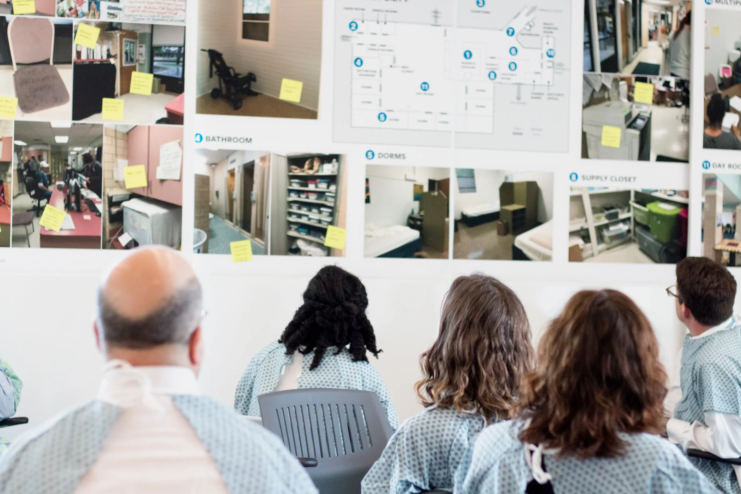At an Integrated Service Design workshop led by the Design Institute for Health, Octavio Martinez, Tracy Asamoah, Amanda Flores, Sydney Harris, and Mike Geeslin review a presentation of the current state facility of ASH.
