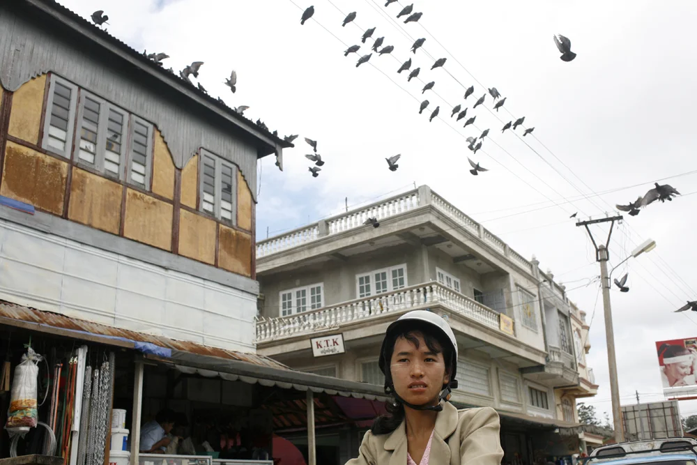  A woman rode a motorbike through a busy market in Pyin-oo-lwin, Myanmar. 