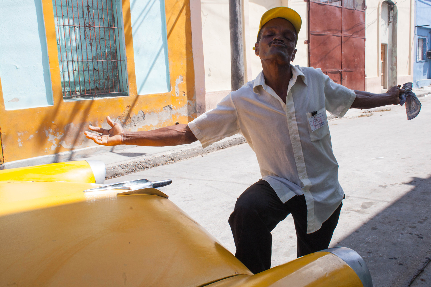  A man sends a kiss, working near the food ration distribution near the port of Santiago de Cuba, Cuba. 