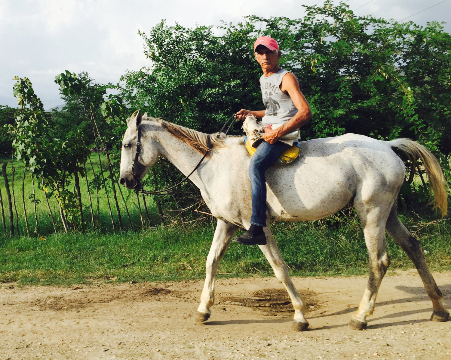  A man rides horse back near the small village towns in the Sierra Maestra mountain region outside of Santiago de Cuba. Many still ride horse carriages in the city to work. 