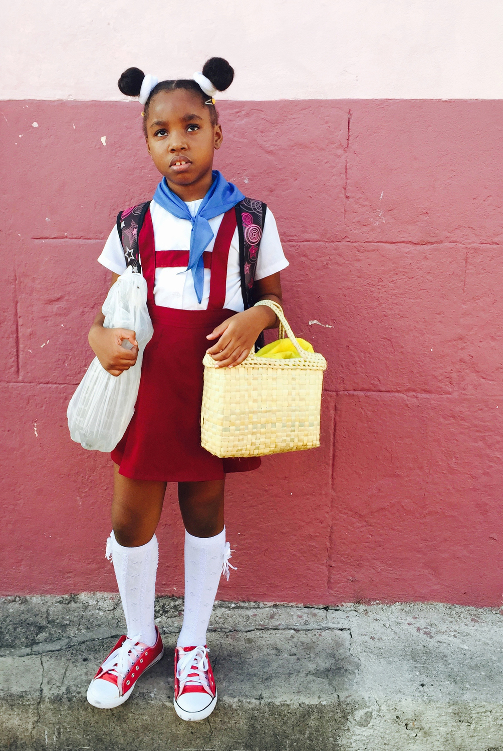  A little girl waits for her mother to walk her to into class in Santiago de Cuba, Cuba.  