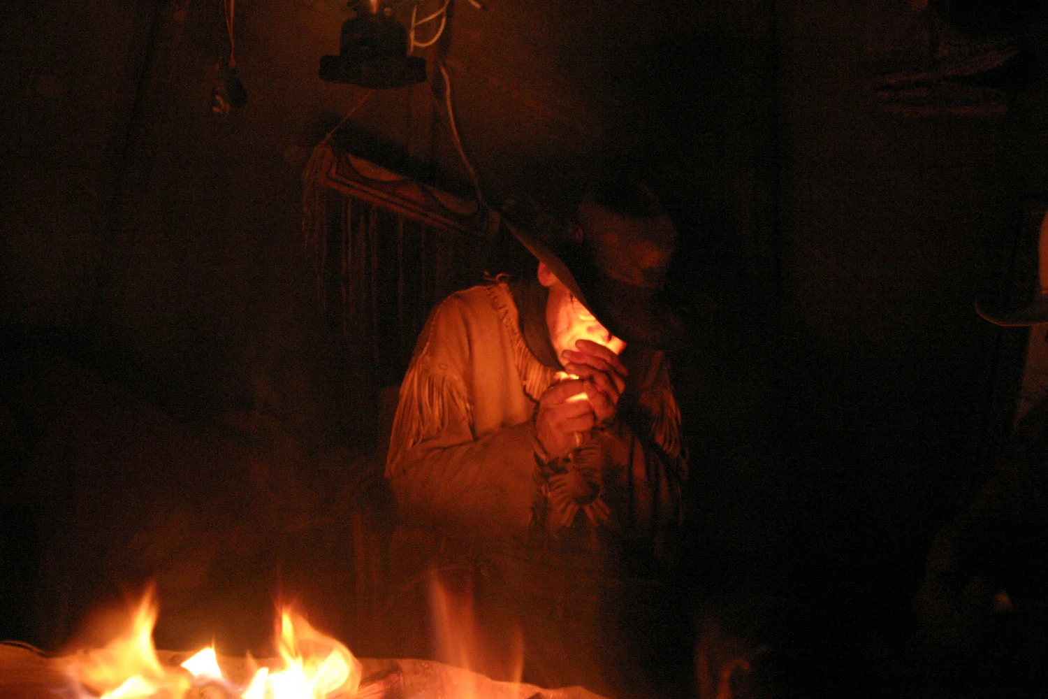 William Smith sparks a smoke at the annual Mountain Man Rendezvous in Jackson, Wyo. He camps out with his friends during a snowy evening in late May.