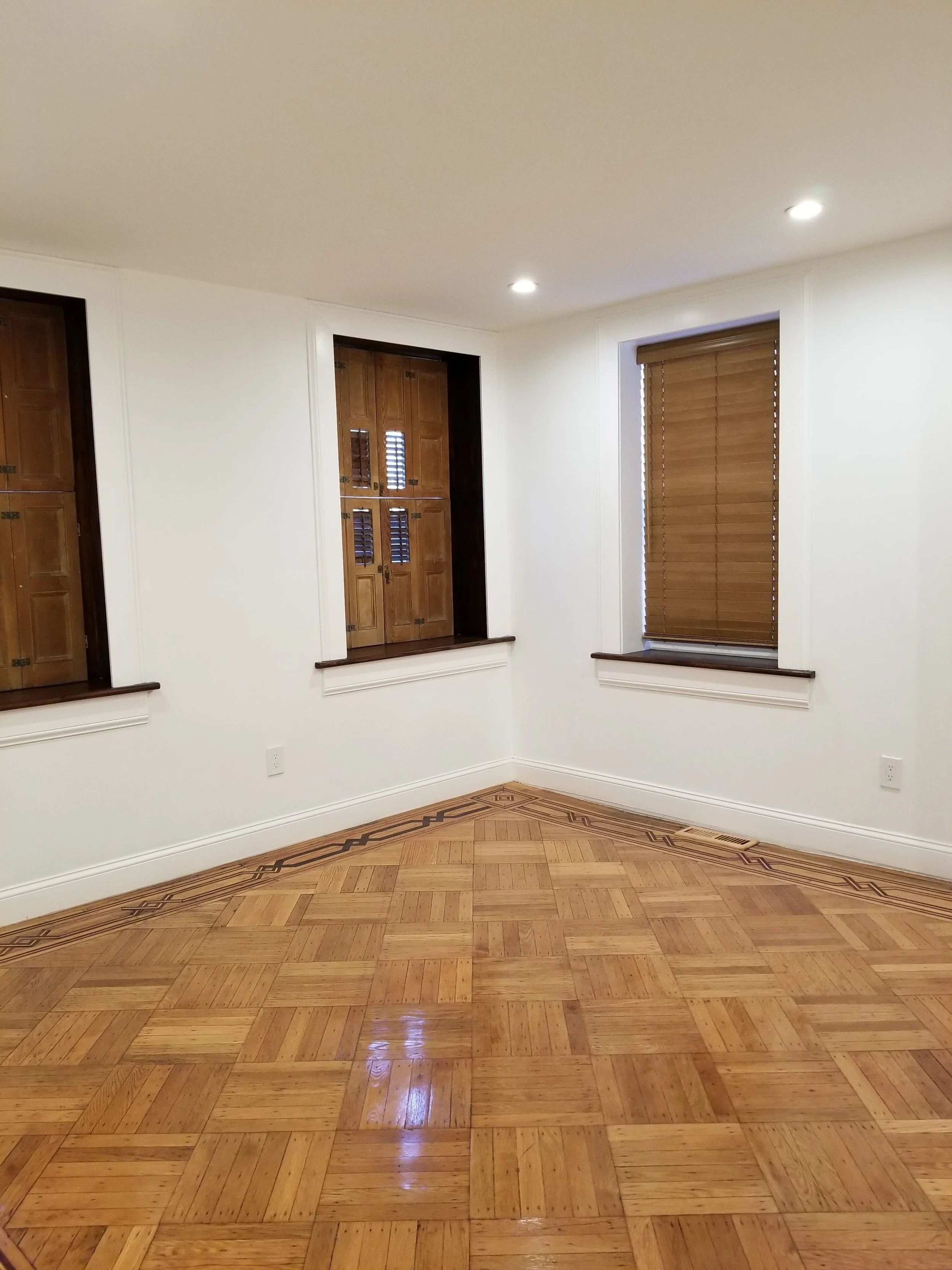 Basement MBR with parquet floors and shutters.jpg