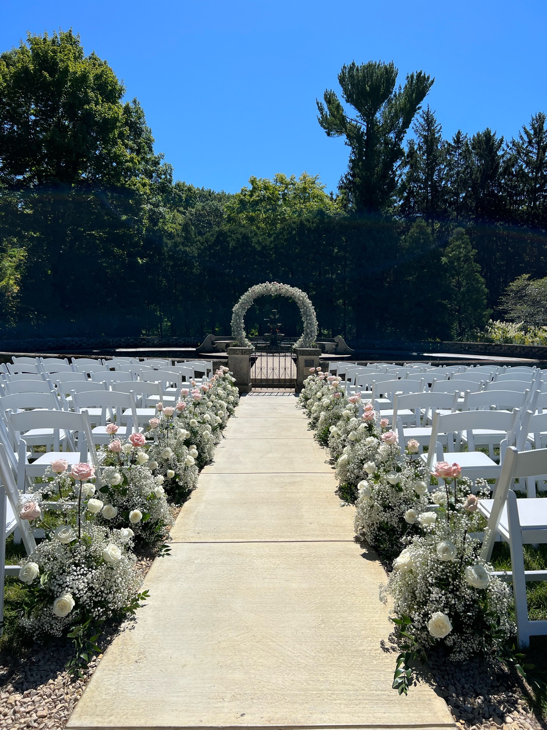 Baby's breath and roses aisle arrangements by WS Floral.jpeg