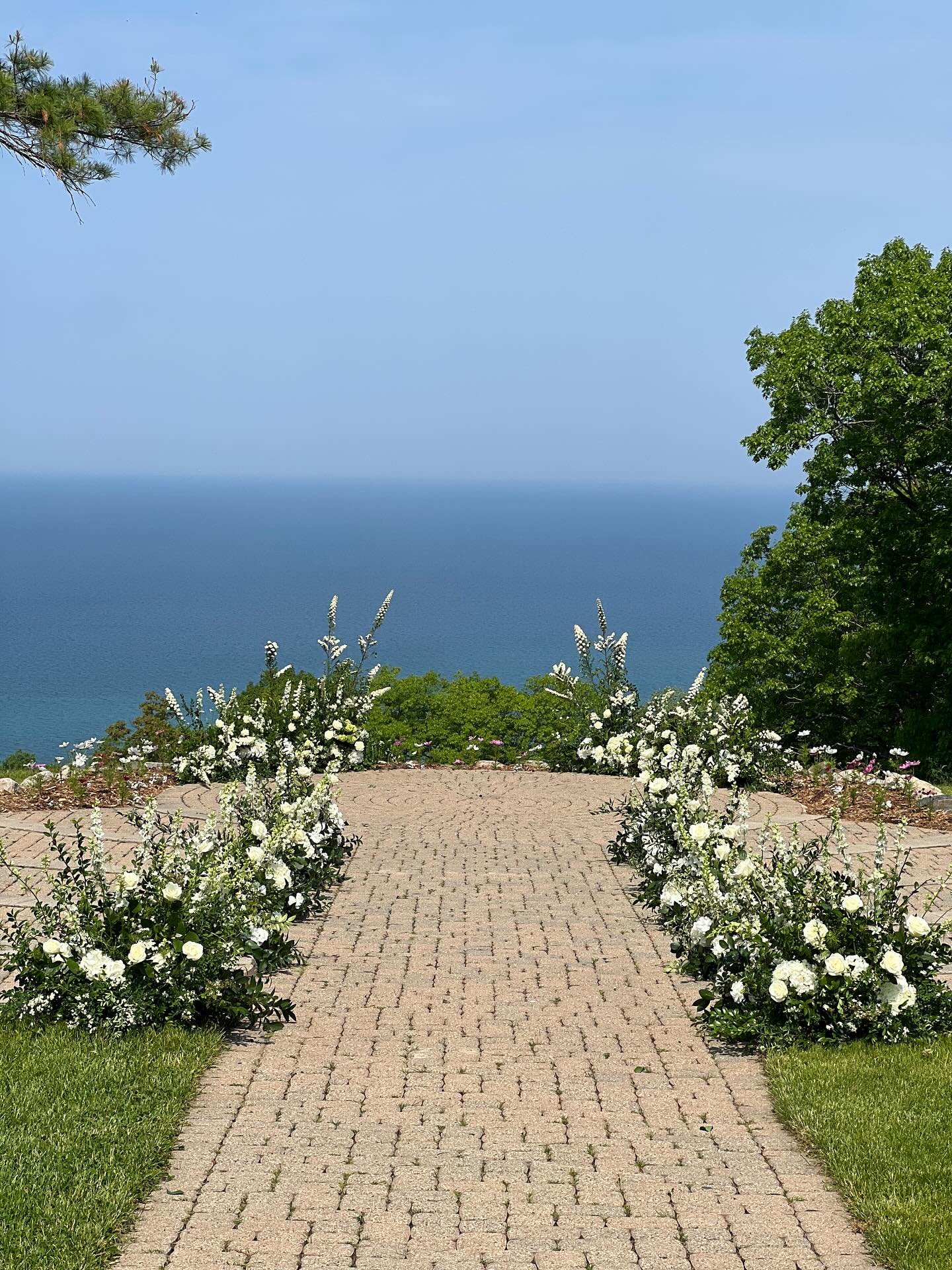 A ceremony site to remember ~ atop Bay Mountain at The Homestead Resort in Glen Arbor, Michigan overlooking Lake Michigan. We can&rsquo;t imagine a more perfect setting for a June wedding in Michigan. We just loved designing these florals, making sur