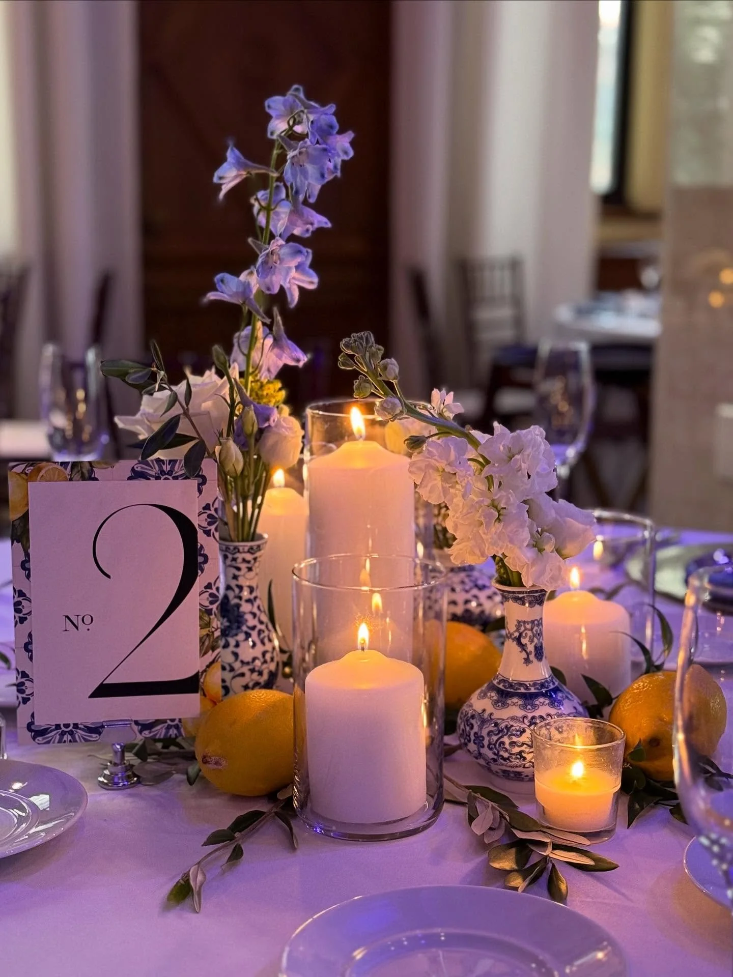 This Mediterranean influenced wedding reception was inspired by the bride&rsquo;s love of her Greek heritage. The nods included lemons and olive branch blended with blue and white ceramics. The fresh cut flowers accented the decor in shades of blue a