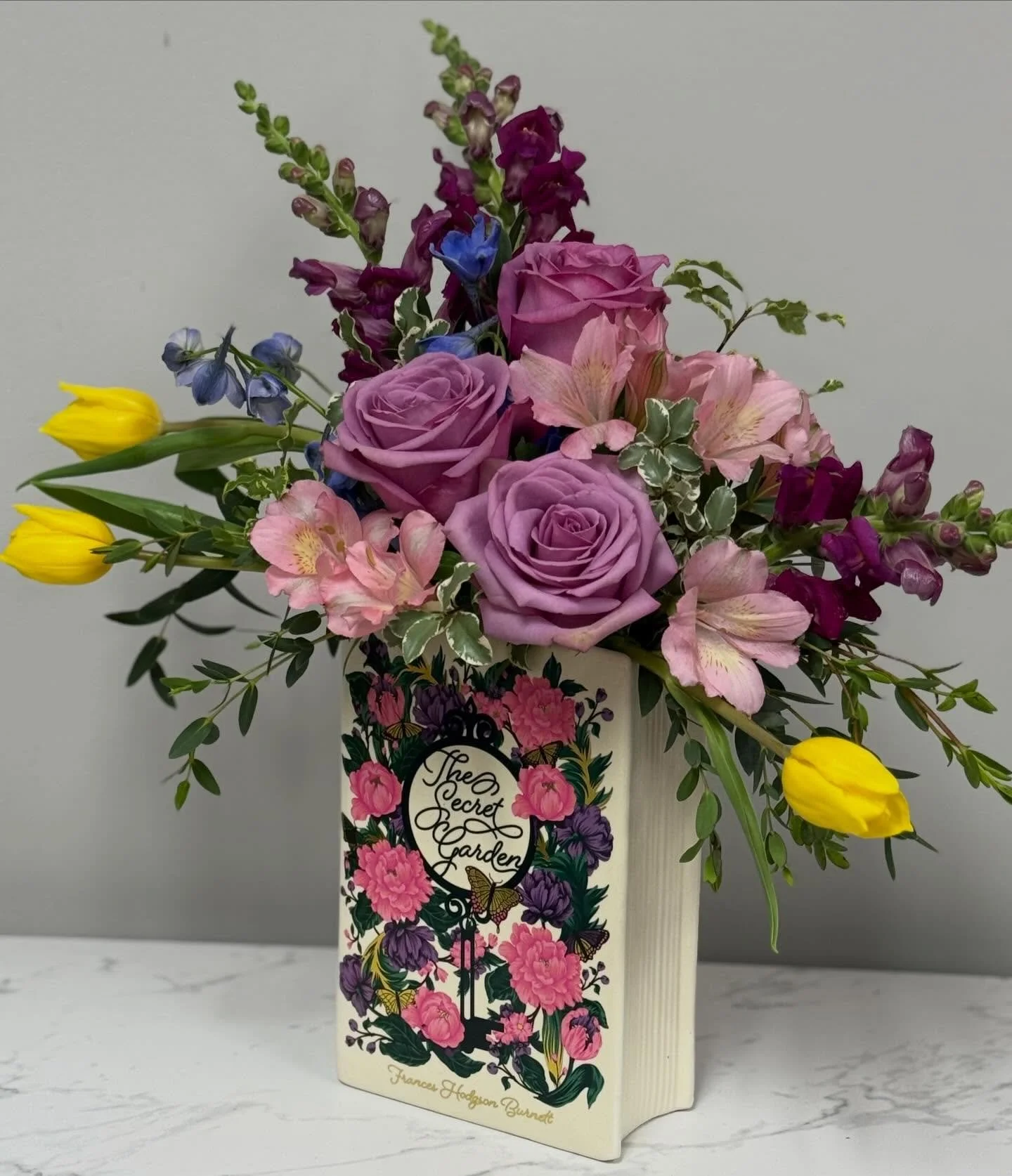 We&rsquo;re working on our spring season collection this week. We just love these book vases by Steel Mill &amp; Co. We&rsquo;ve paired The Secret Garden with lavender roses, yellow tulips, and deep wine snapdragons. A book lover&rsquo;s dream.