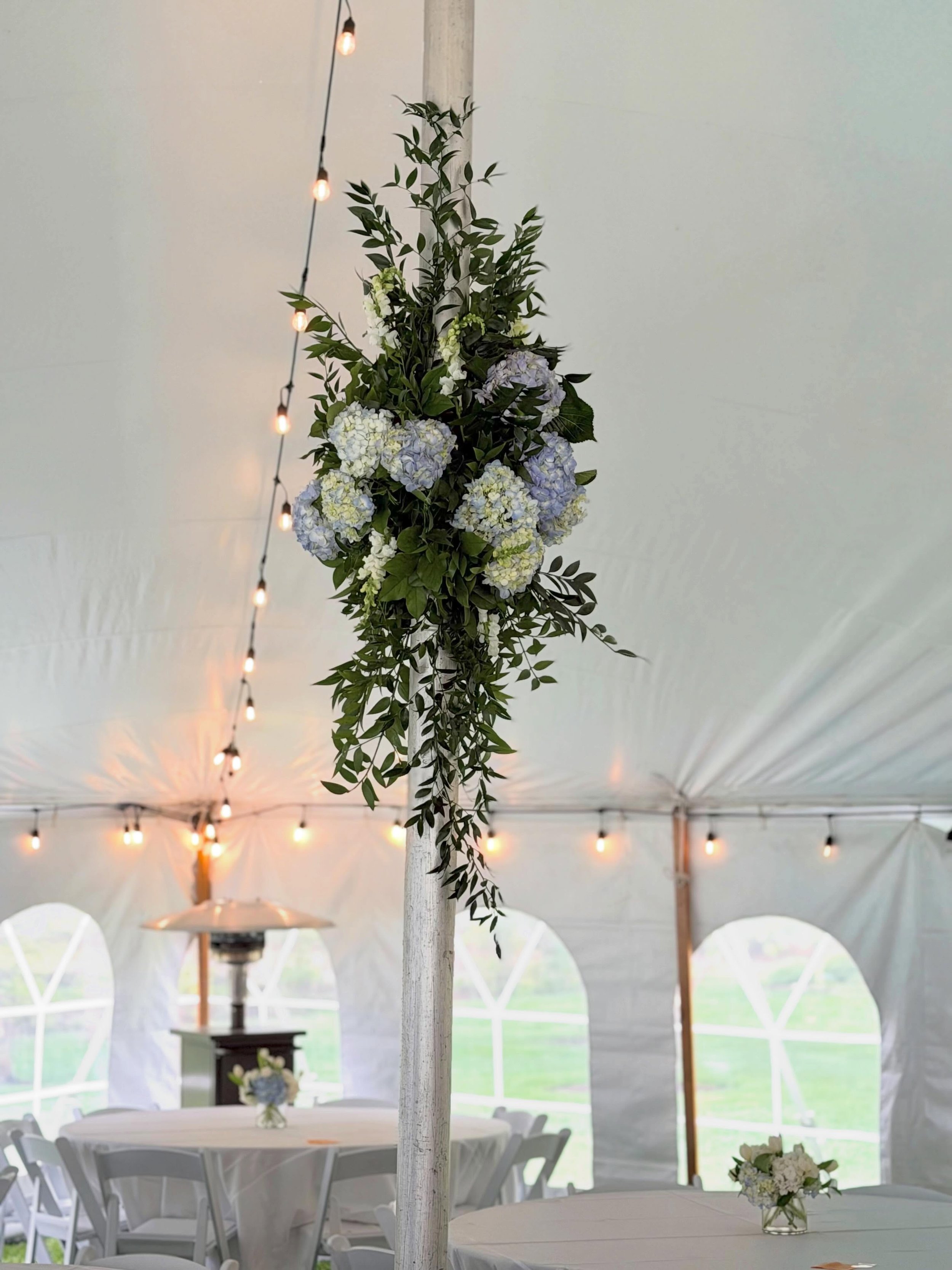 Floral installation on the tent poles using hydrangeas and Italian ruscus for last Saturday&rsquo;s wedding.