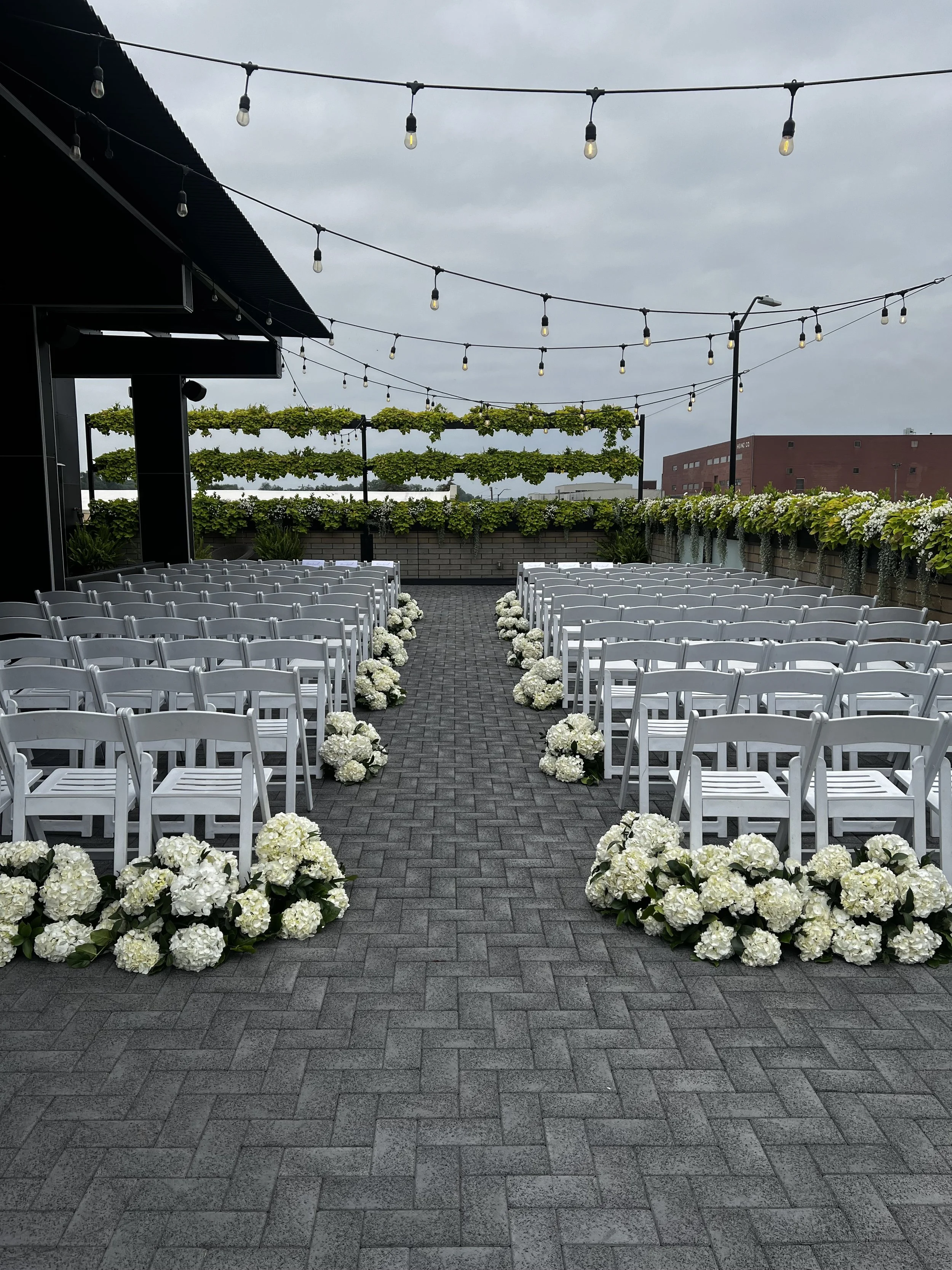White hydrangea aisle arrangements by WS Floral at Port 393 rooftop.jpeg
