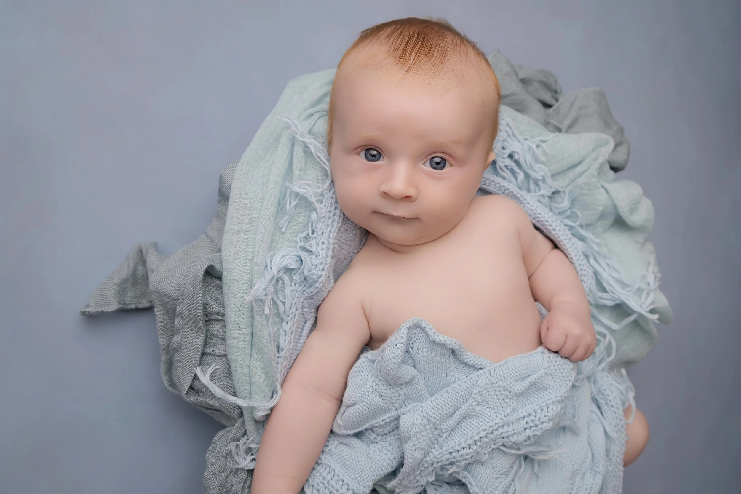 Curious baby exploring during a natural baby photoshoot in Ickwell, Bedfordshire.