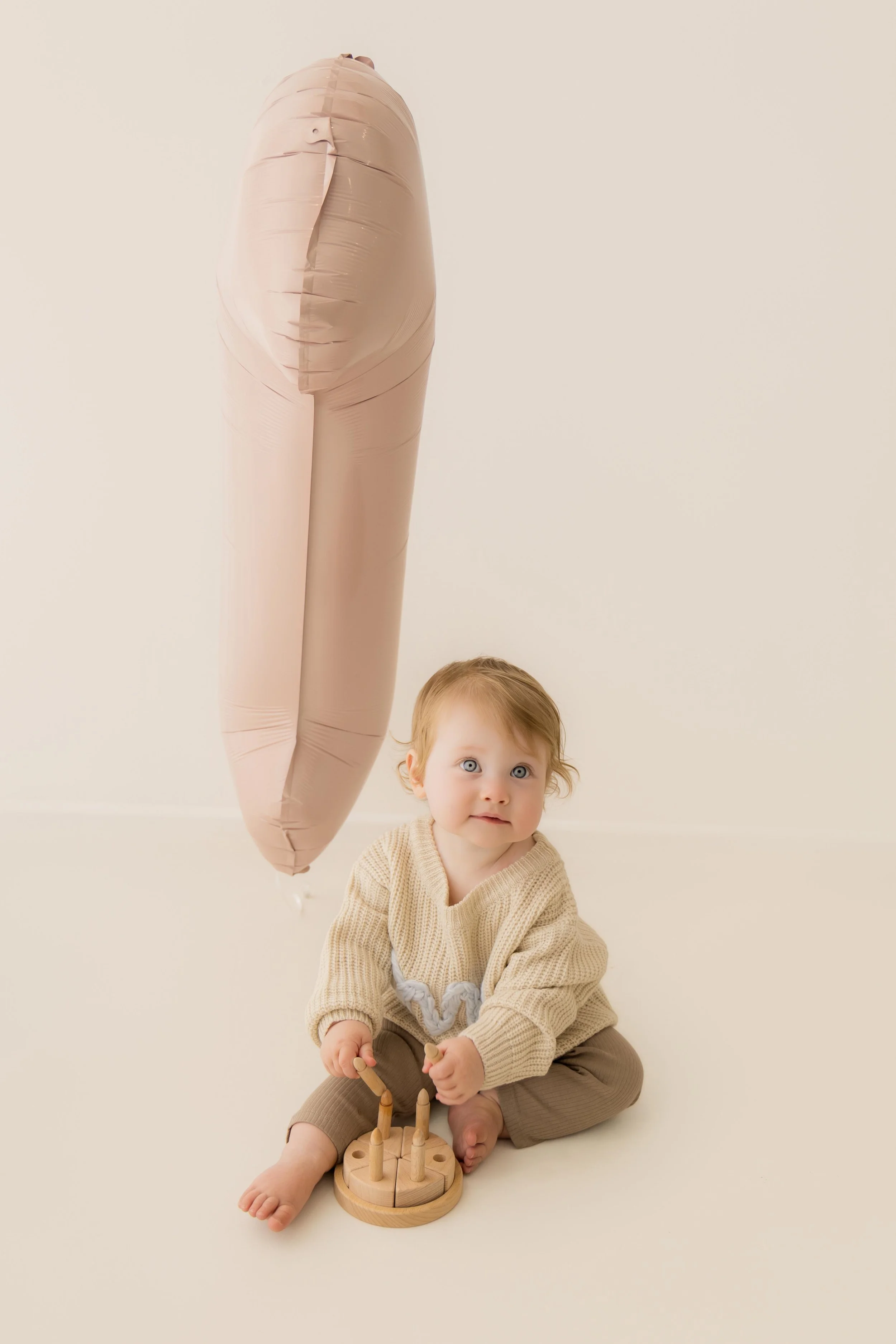 first birthday little girl with pink balloon biggleswade