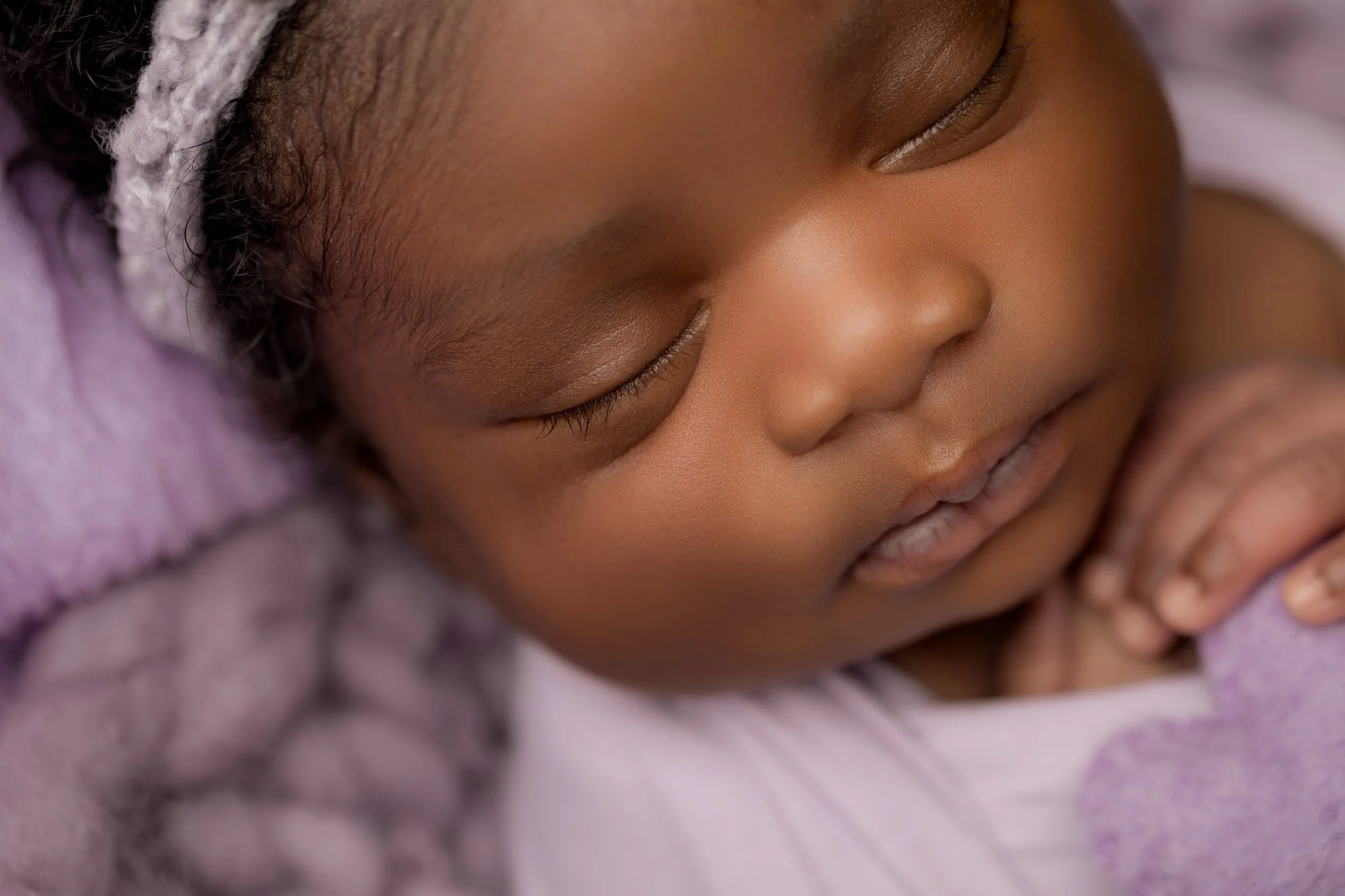 newborn baby girl in purple bedfordshire studio