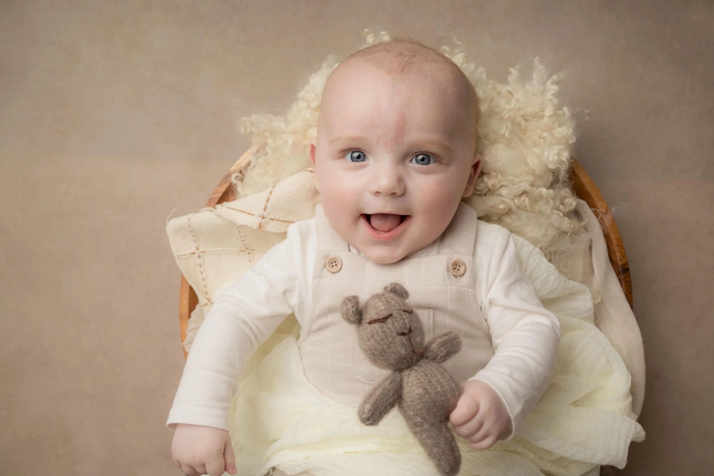 Baby laughing during a milestone photography session at Phoebe Berridge Photography