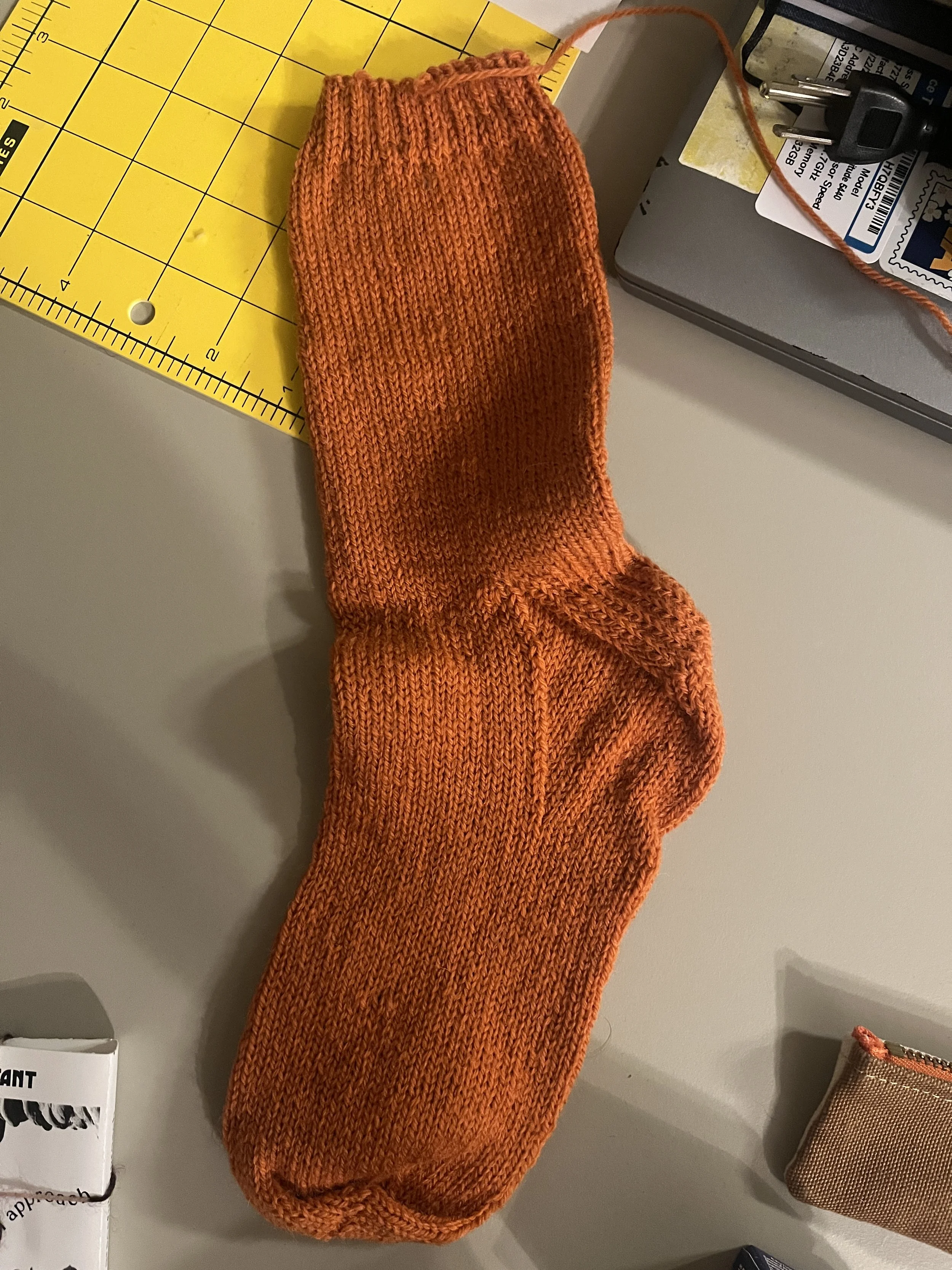 A hand-knit orange sock.