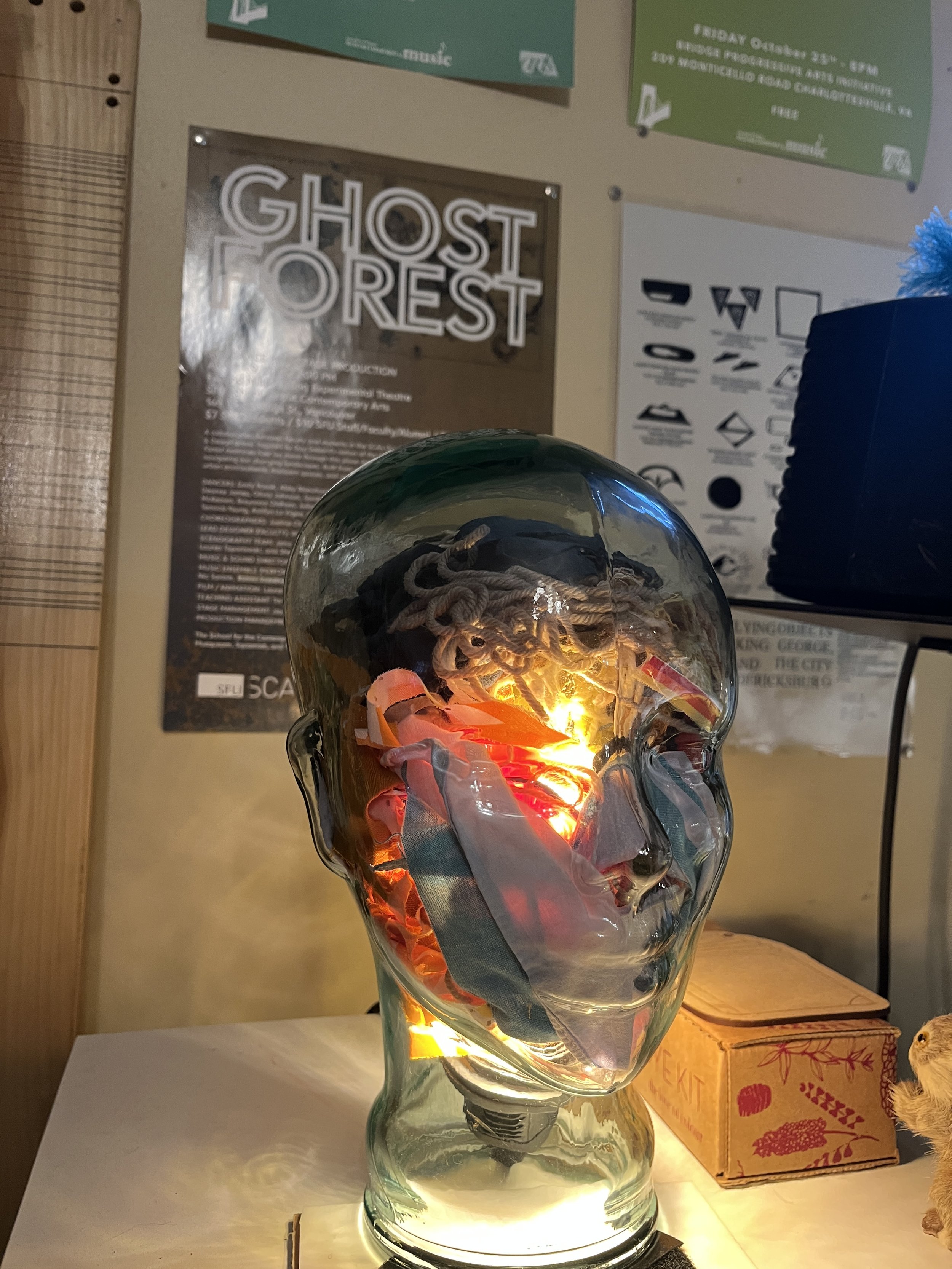 A glass head lamp full of my yarn and fabric scraps.
