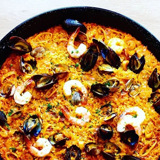 Paella: the perfect summer backyard picnic dish. Available daily for lunch and dinner- order online or visit us in store. 🥘